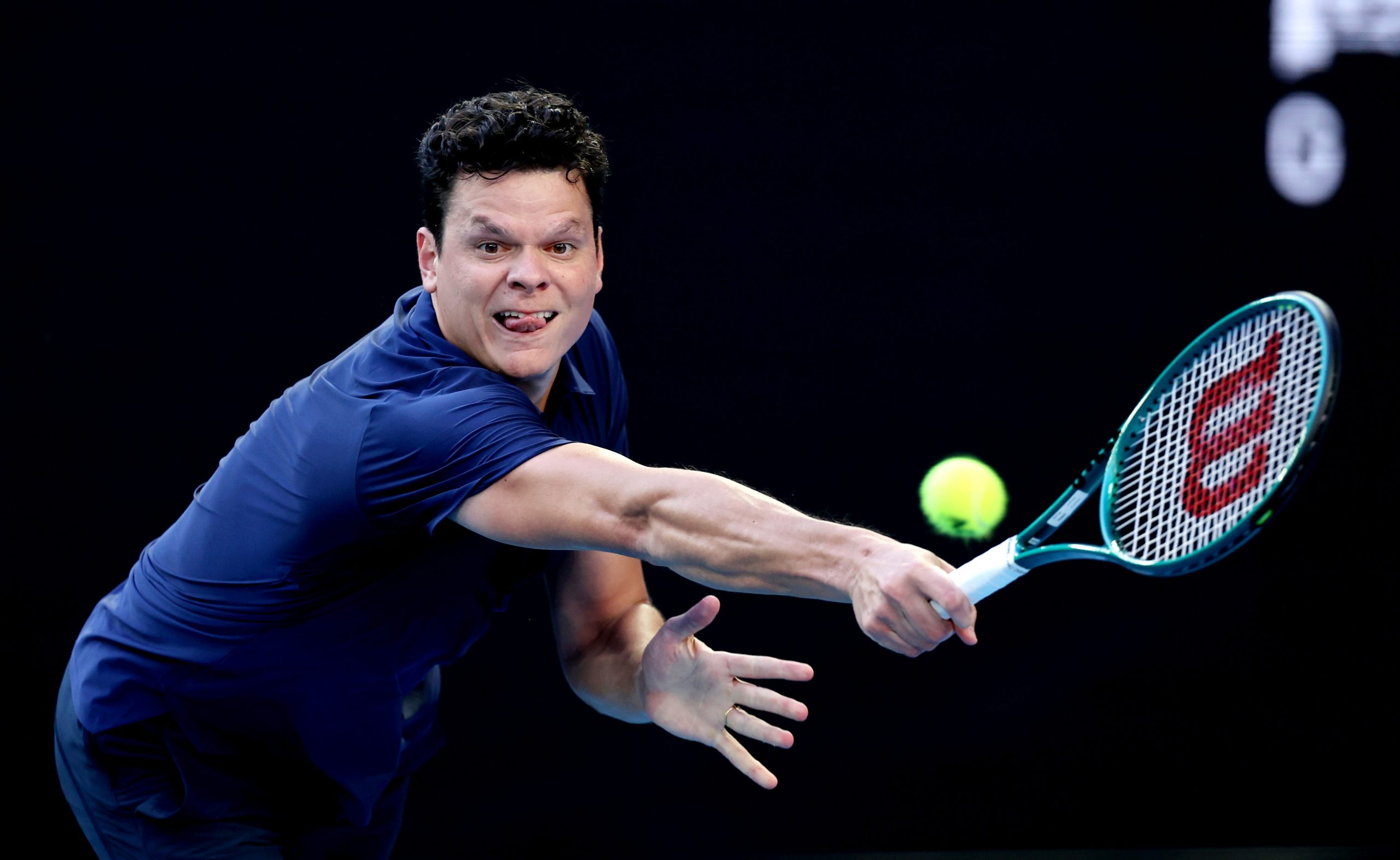 Milos Raonic of Canada plays a backhand in their round one singles match against Alex de Minaur of Australia during the 2024 Australian Open at Melbourne Park on January 15, 2024 in Melbourne, Australia. (Photo by Cameron Spencer/Getty Images)
