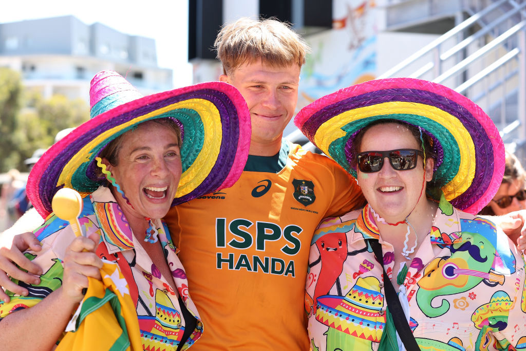 Darby Lancaster of Australia poses with fans.