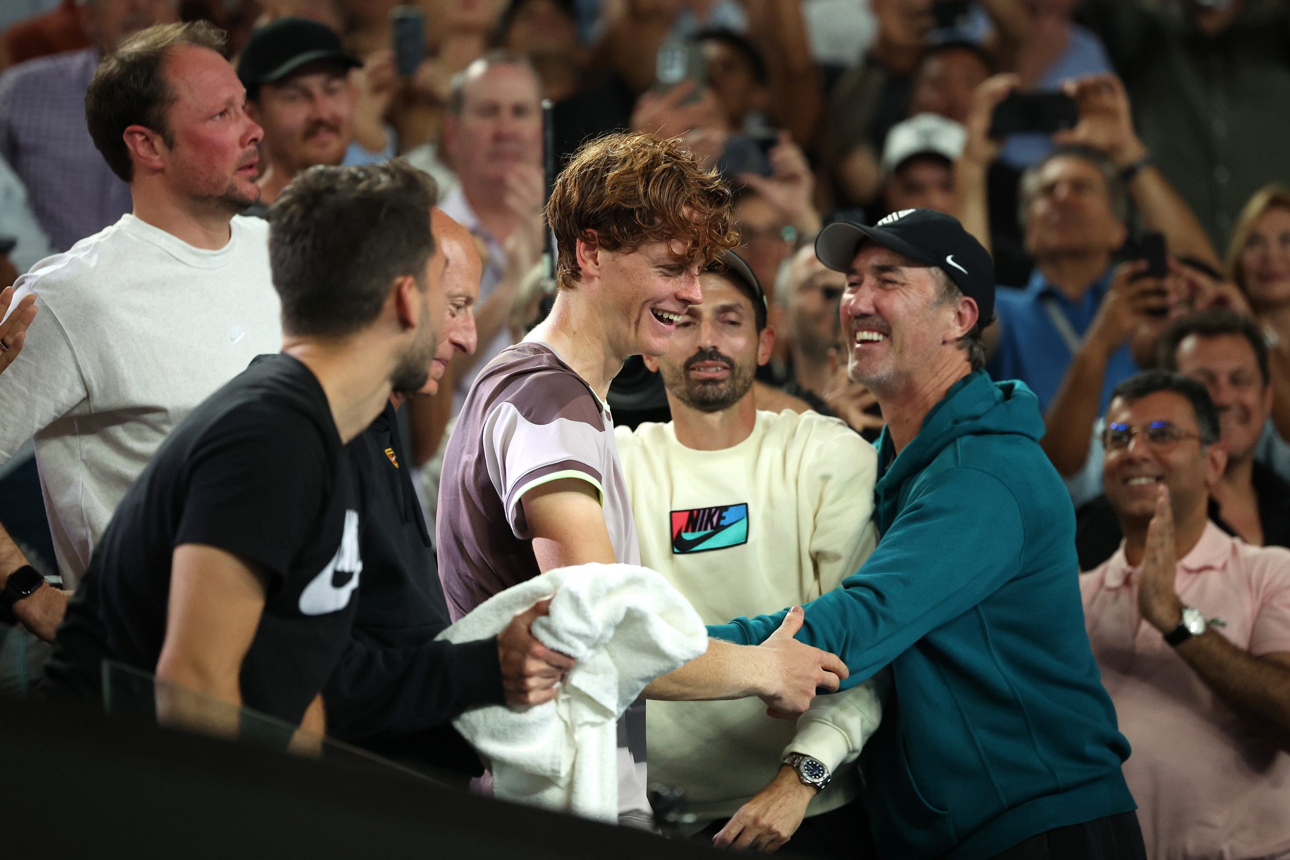 Jannik Sinner of Italy celebrates winning with coach Darren Cahill and his team.