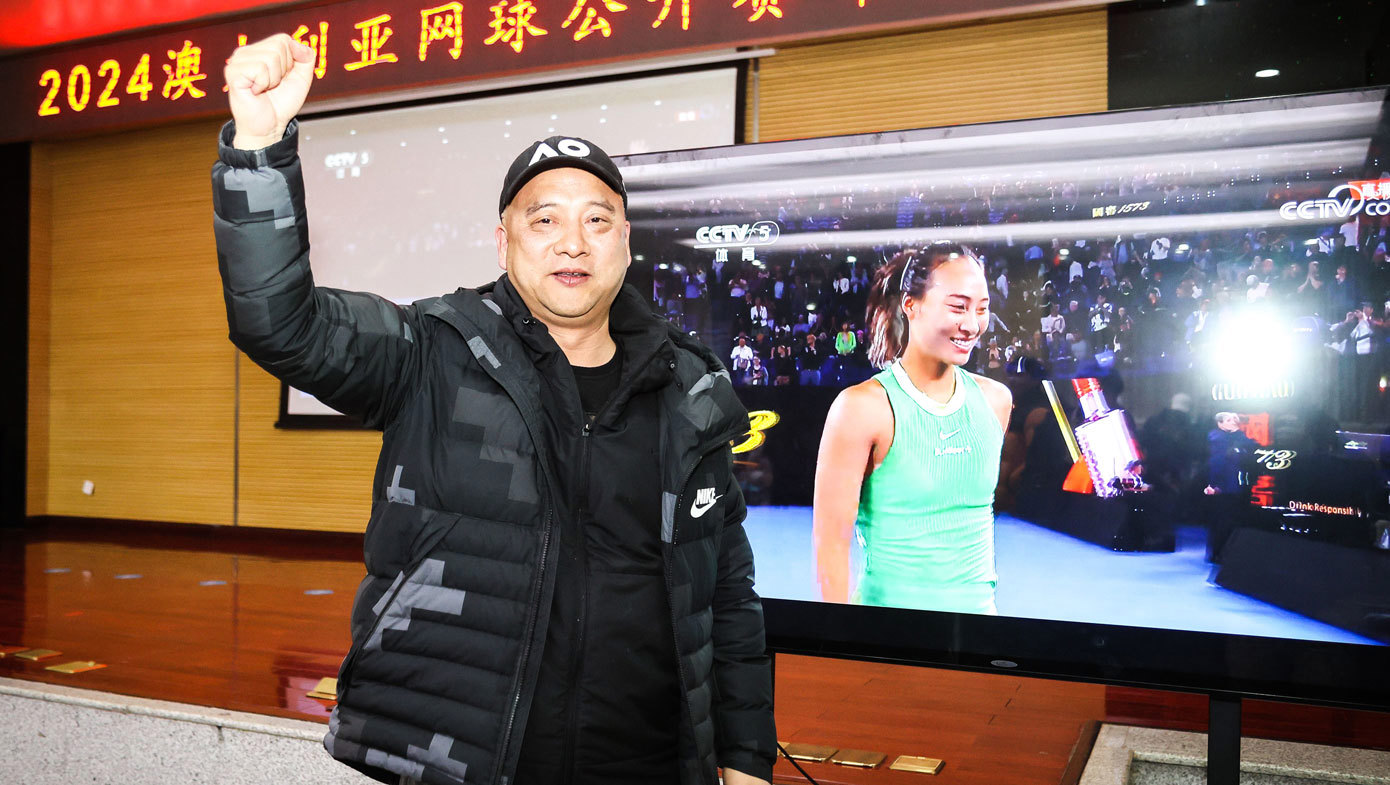 Zheng Jianping, Zheng Qinwen's father, celebrates at Hubei Olympic Sports Center after his daughter won her Australian Open semi-final.