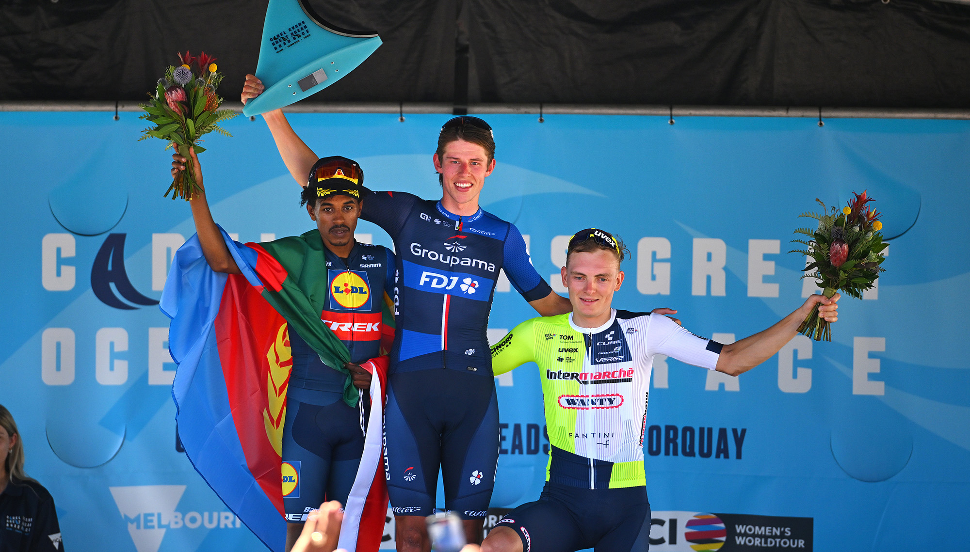 Natnael Tesfazion of Eritrea and Team Lidl-Trek on second place, race winner Laurence Pithie of New Zealand and Team Groupama-FDJ and Georg Zimmermann of Germany and Team Intermarche-Wanty on third place pose on the podium.