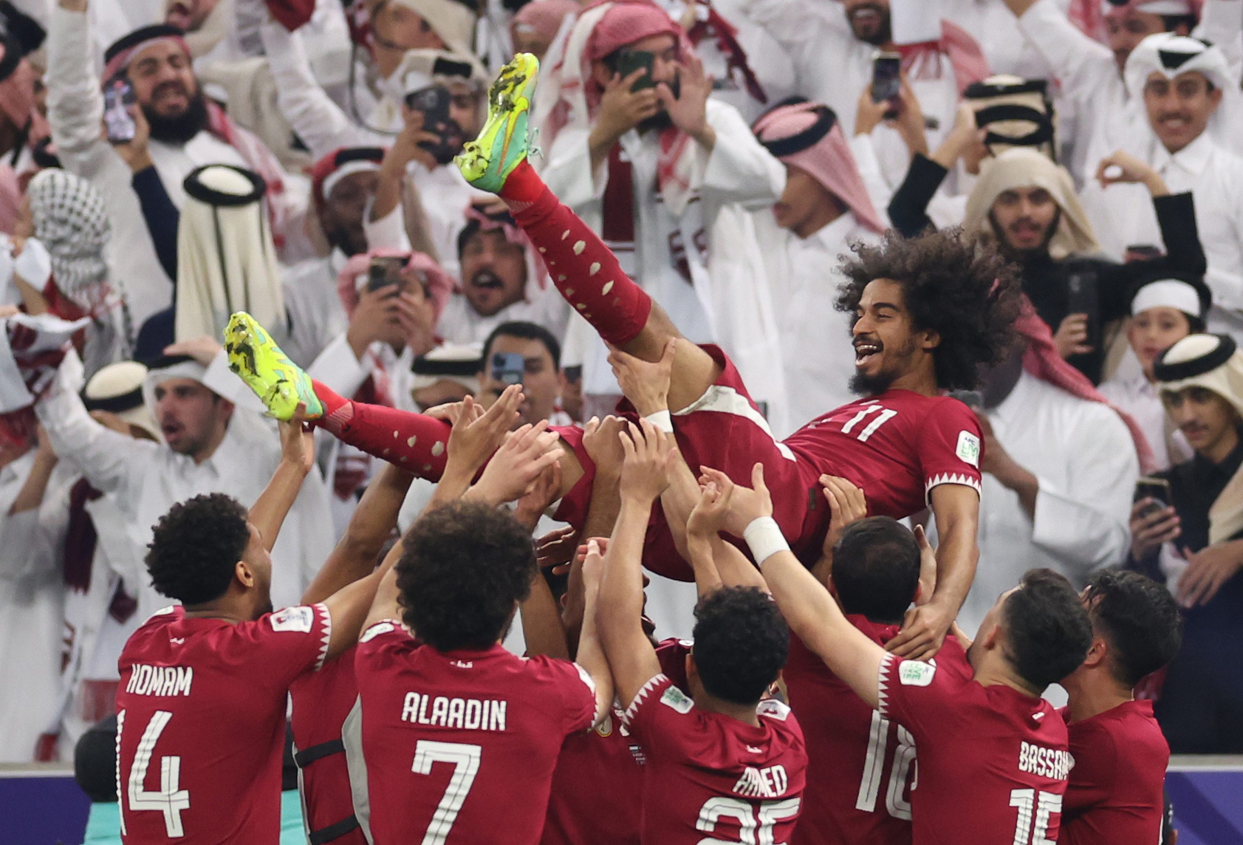Akram Afif of Qatar celebrates with team mates following their sides victory in the AFC Asian Cup final match between Jordan and Qatar at Lusail Stadium on February 10, 2024 in Lusail City, Qatar. (Photo by Robert Cianflone/Getty Images)