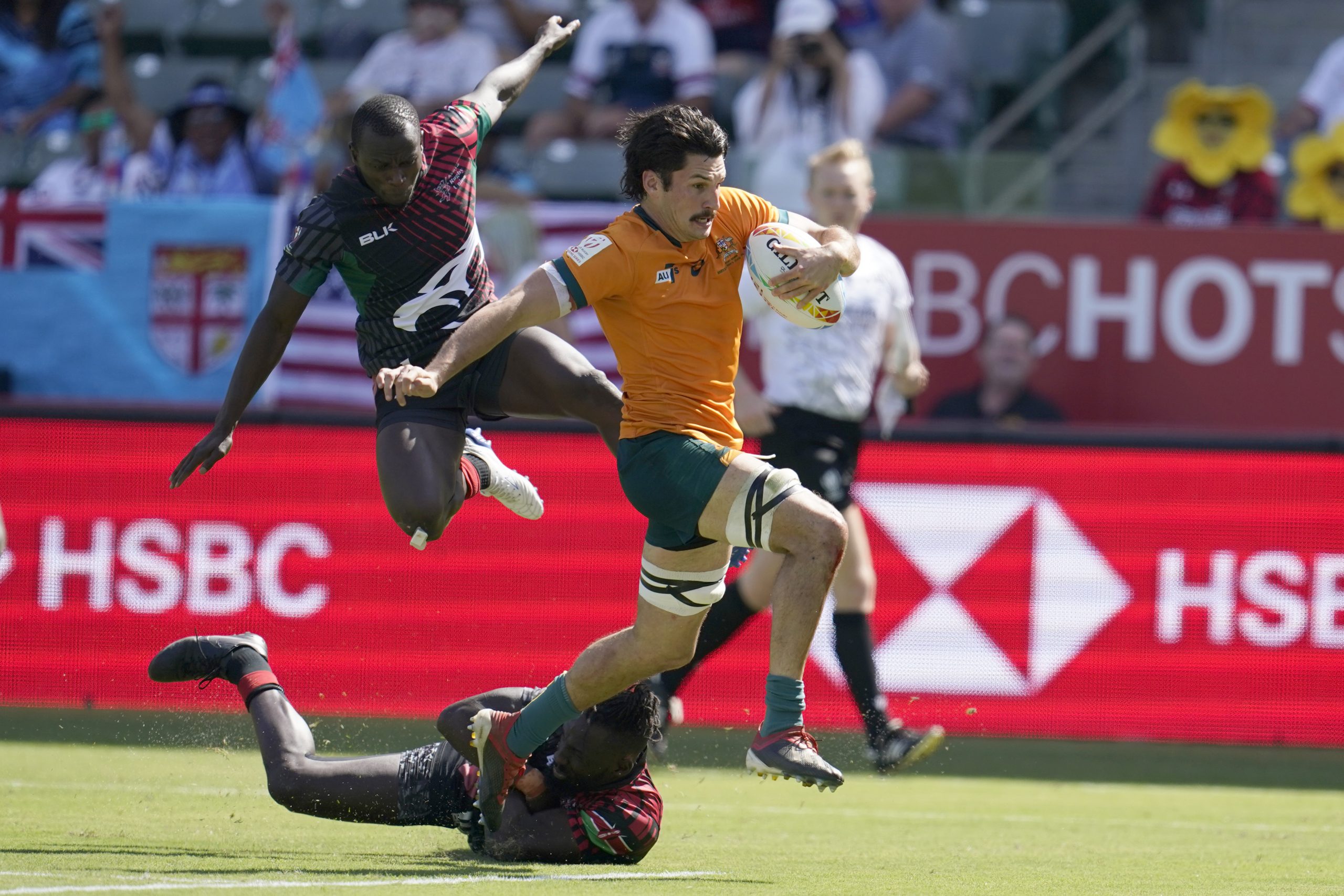 Australia's Henry Paterson evades the Kenyan defence to score a try.
