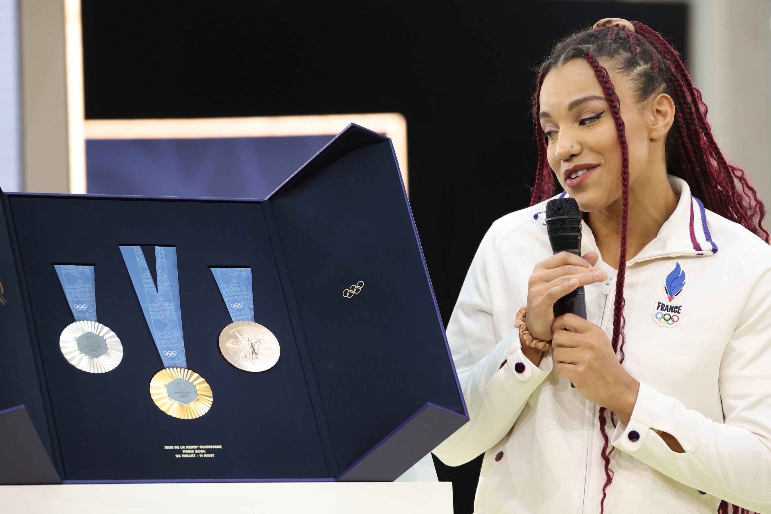 French Olympic wrestler Koumba Larroque marvels at the medals.