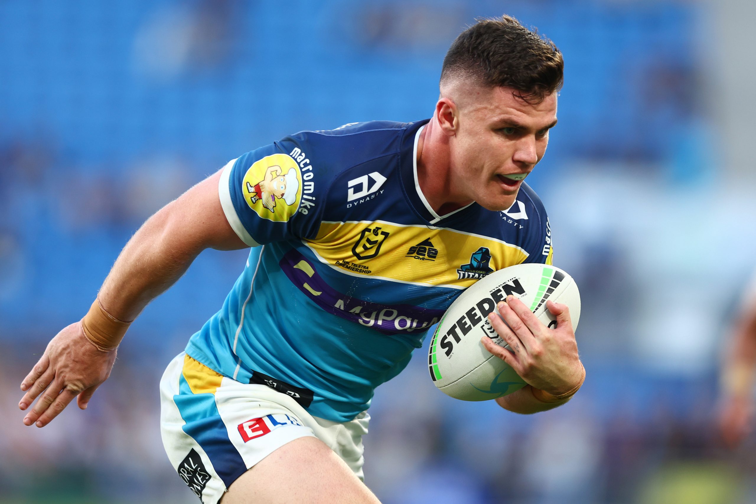 Beau Fermor of the Titans makes a break to score a try during the round 24 NRL match between the Gold Coast Titans and the Newcastle Knights at Cbus Super Stadium, on August 28, 2022, in Gold Coast, Australia. (Photo by Chris Hyde/Getty Images)