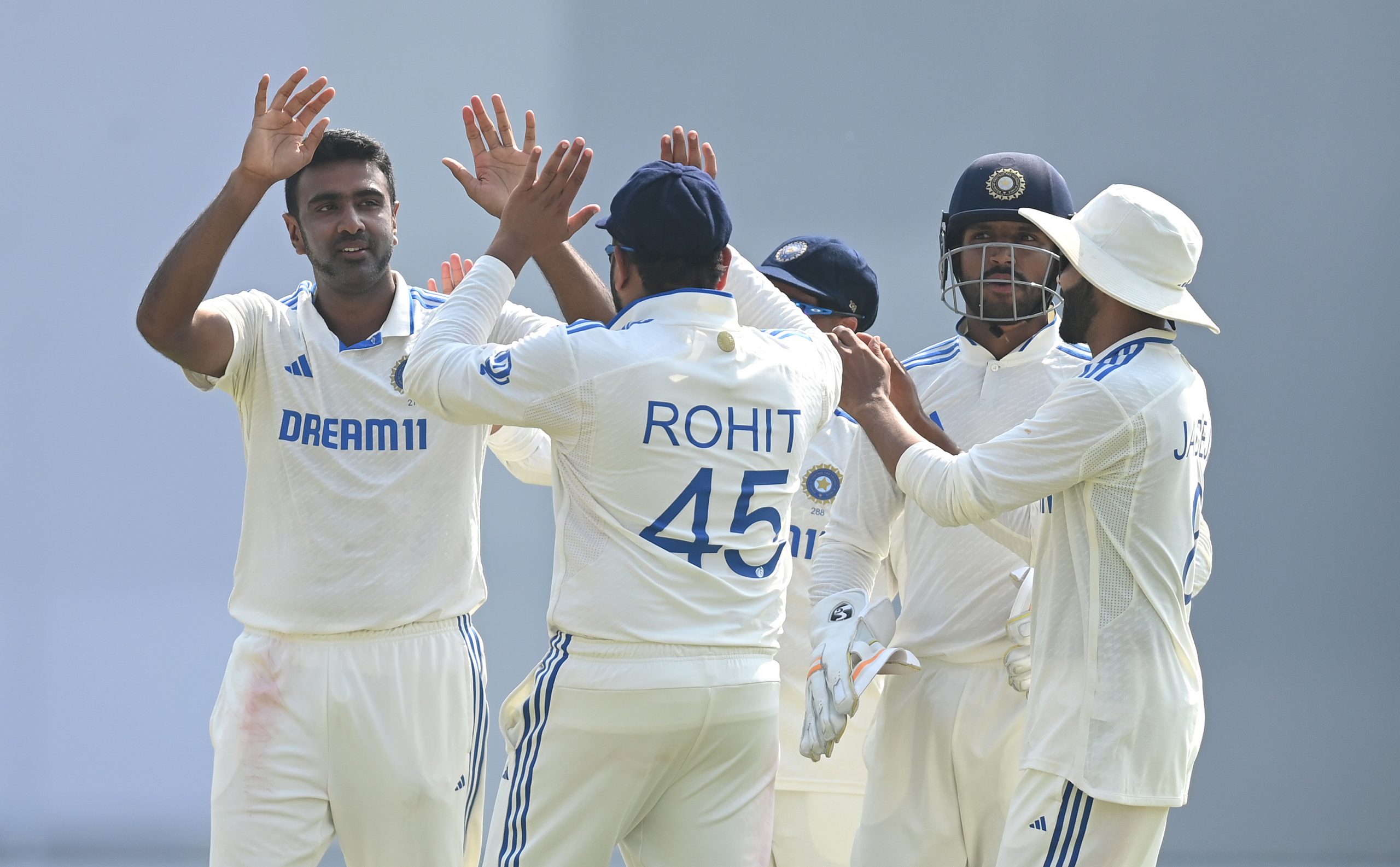 India bowler Ravi Ashwin is congratulated by captain Rohit Sharma after taking the wicket of Zak Crawley to reach his 500th Test Wicket during day two of the 3rd Test Match between India and England at Saurashtra Cricket Association Stadium on February 16, 2024 in Rajkot, India. (Photo by Gareth Copley/Getty Images)