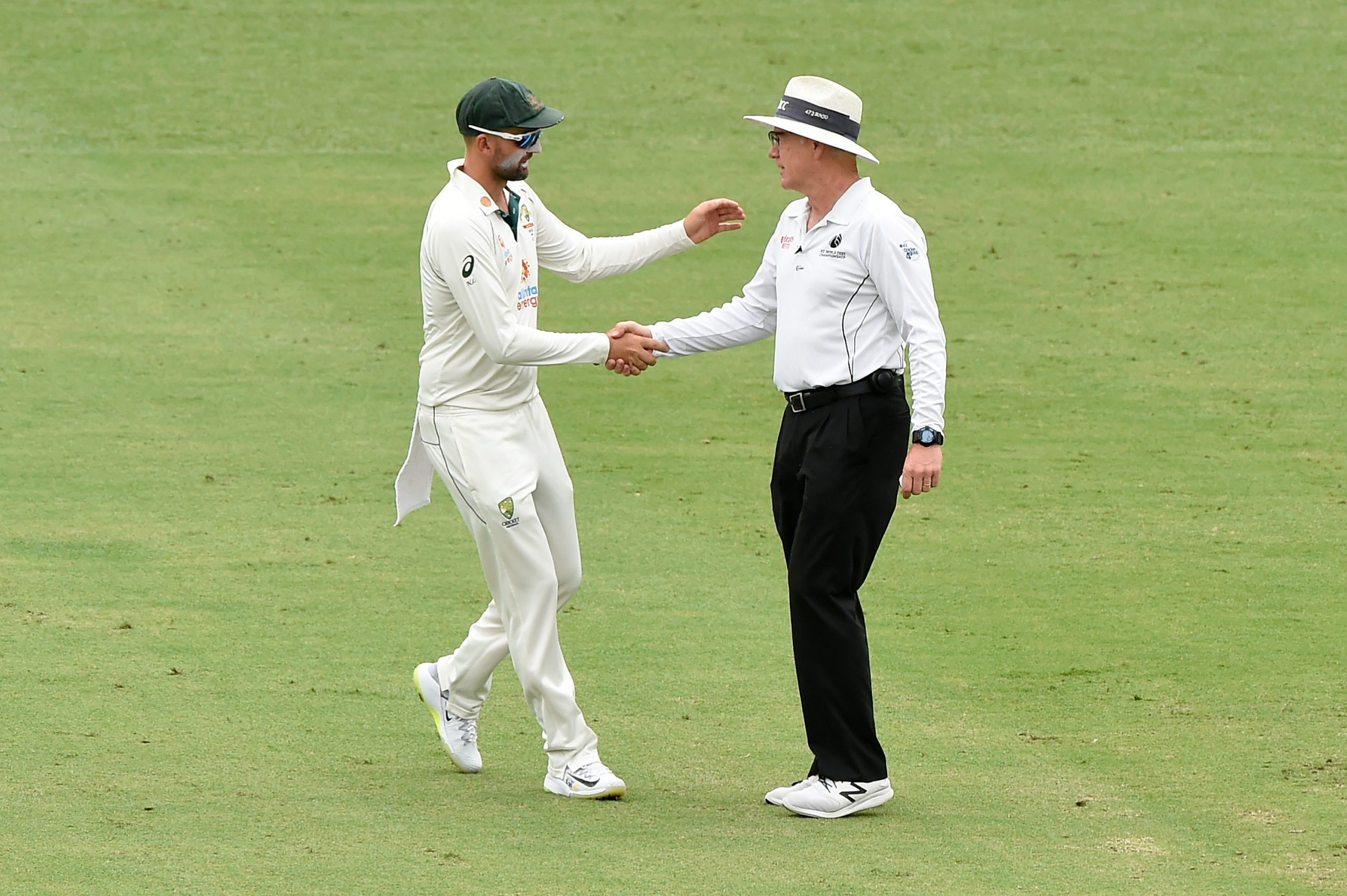 Nathan Lyon of Australia shakes hands with umpire Bruce Oxenford.