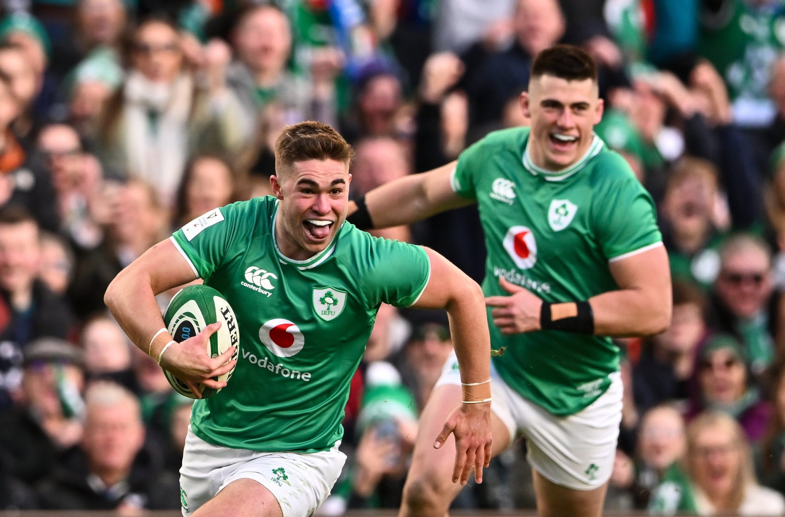 Jack Crowley (left) of Ireland runs in to score his side's first try during the Six Nations against Italy.