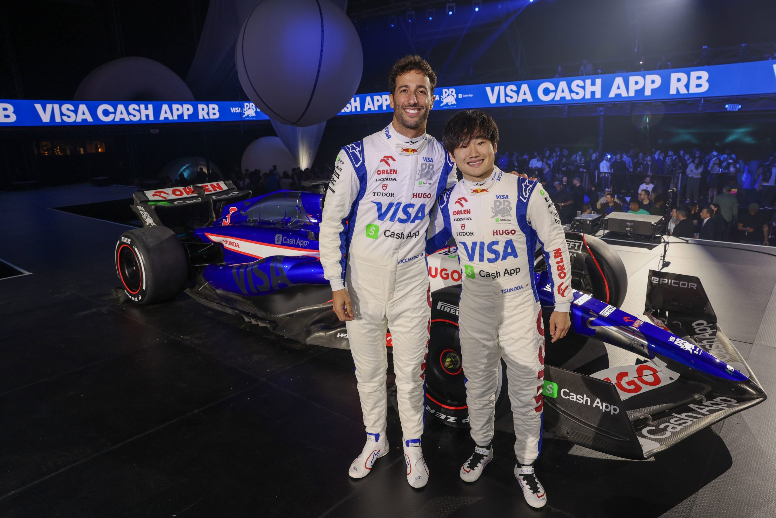 Daniel Ricciardo of Australia and Visa Cash App RB and Yuki Tsunoda of Japan and Visa Cash App RB pose for a photo with the Visa Cash App RB VCARB 01 at the Visa Cash App RB Livery Launch Event Las Vegas on February 08, 2024 in Las Vegas, Nevada. (Photo by Jesse Grant/Getty Images for Visa Cash App RB) // Getty Images / Red Bull Content Pool // SI202402090079 // Usage for editorial use only //