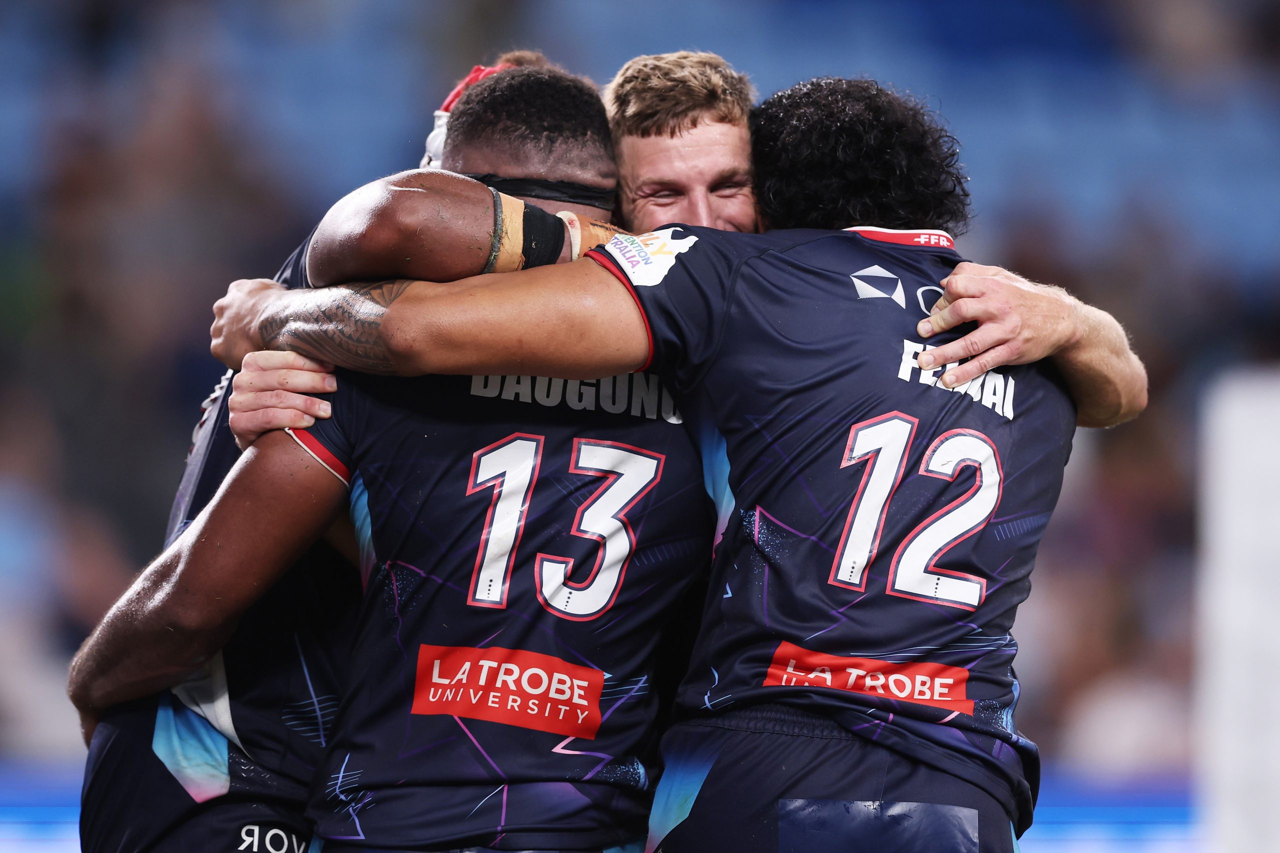 Filipo Daugunu of the Rebels celebrates with team mates after scoring the final try during the round six Super Rugby Pacific match against the Waratahs.