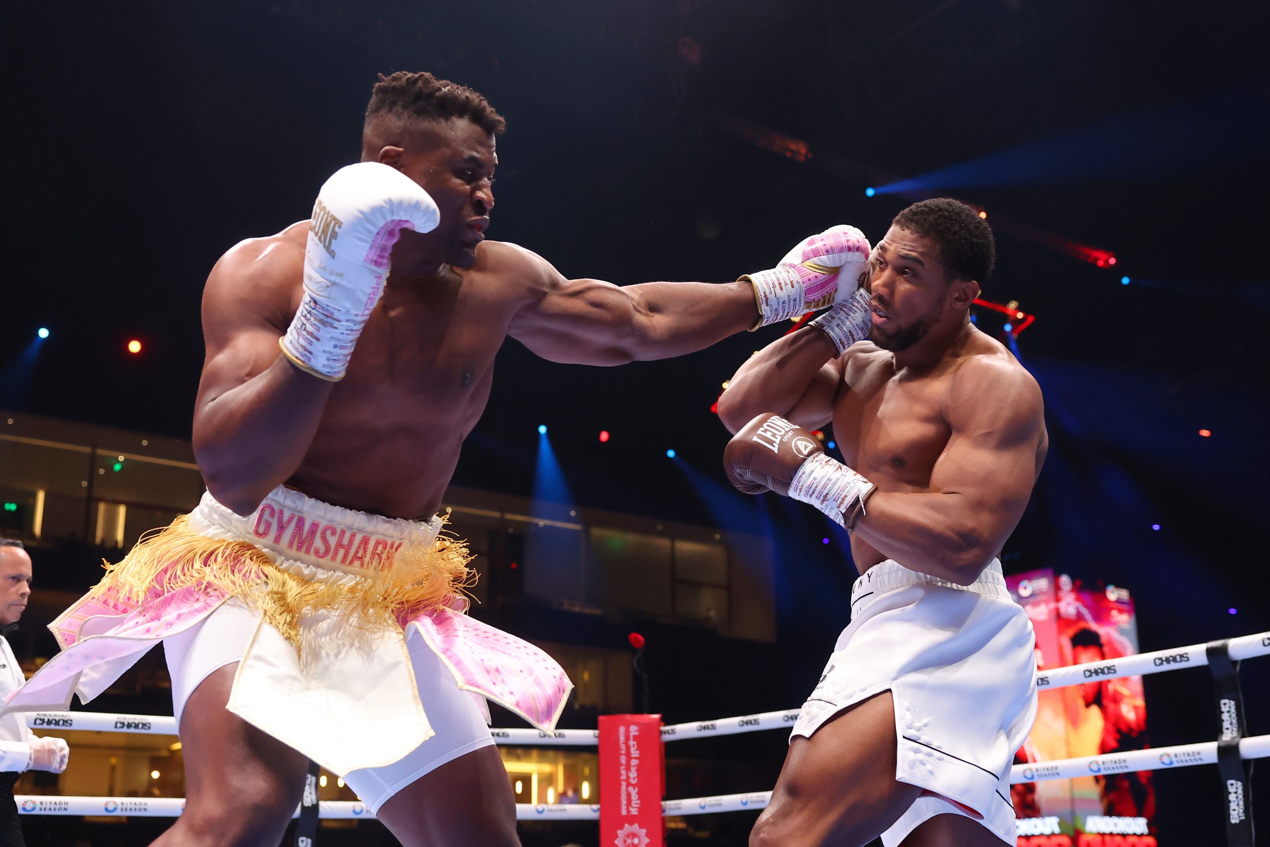 Francis Ngannou punches Anthony Joshua during the Heavyweight fight between Anthony Joshua and Francis Ngannou on the Knockout Chaos boxing card at the Kingdom Arena on March 08, 2024 in Riyadh, Saudi Arabia. (Photo by Richard Pelham/Getty Images)