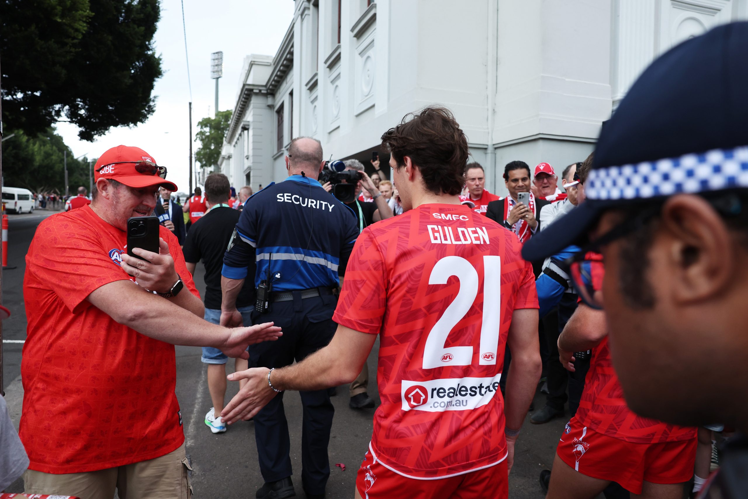 Errol Gulden high fives a fan on the march to the SCG.