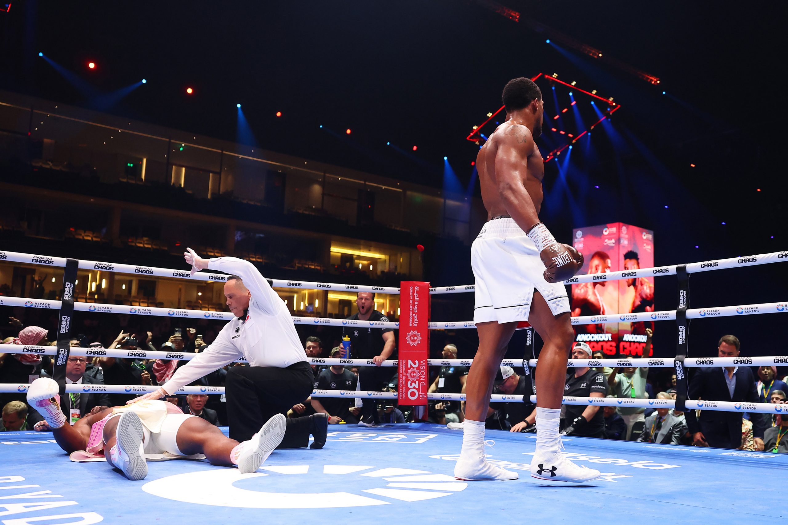 Francis Ngannou is knocked down for the third time as Referee Ricky Gonzalez stops the fight and checks on him during the Heavyweight fight between Anthony Joshua and Francis Ngannou on the Knockout Chaos boxing card at the Kingdom Arena on March 08, 2024 in Riyadh, Saudi Arabia. (Photo by Richard Pelham/Getty Images)