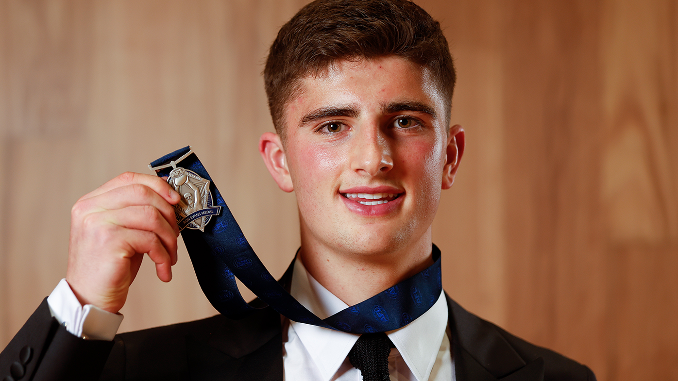 North Melbourne's Harry Sheezel poses with the Rising Star award.