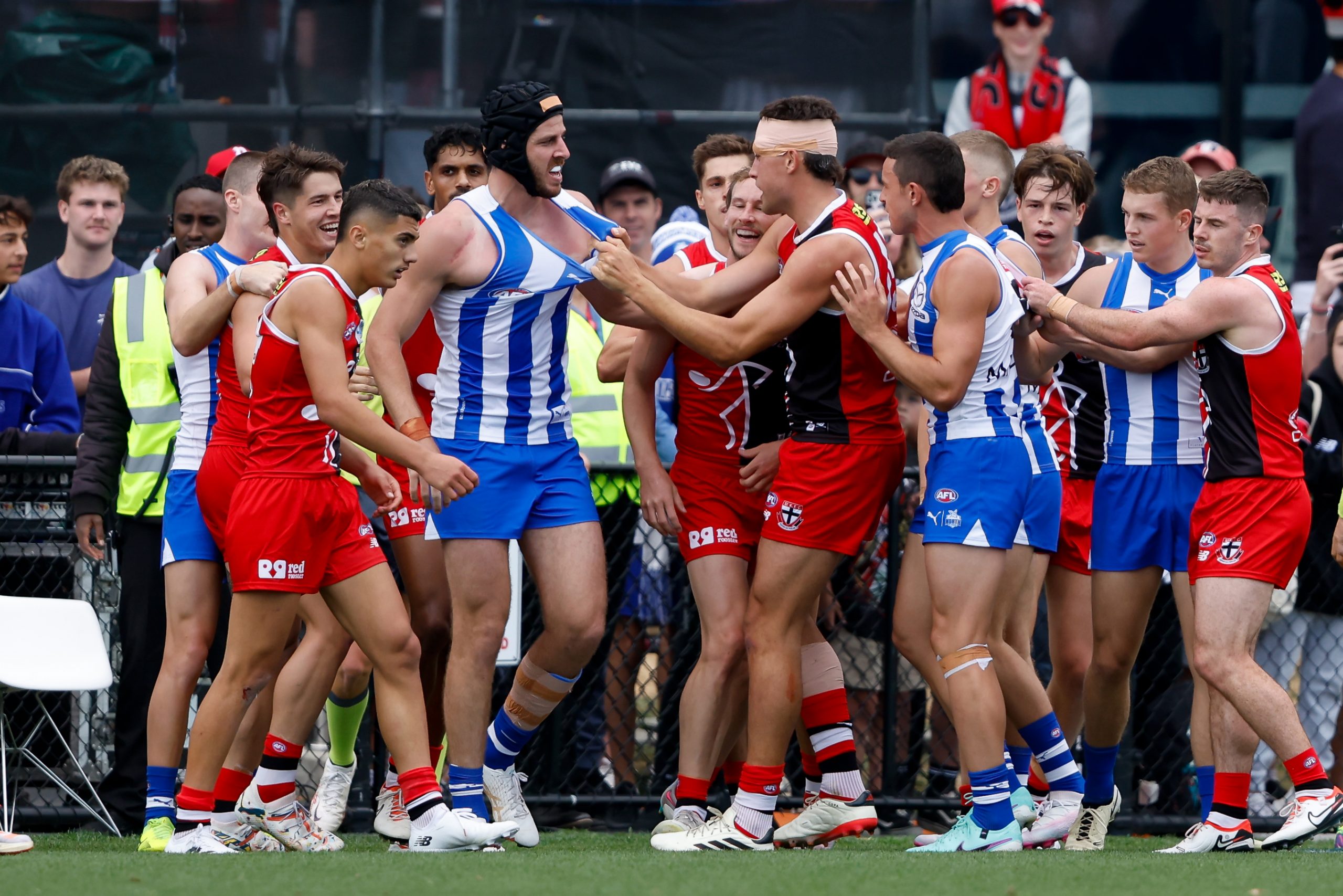 Players remonstrate as Jy Simpkin of the Kangaroos lays injured after the hit from Jimmy Webster.