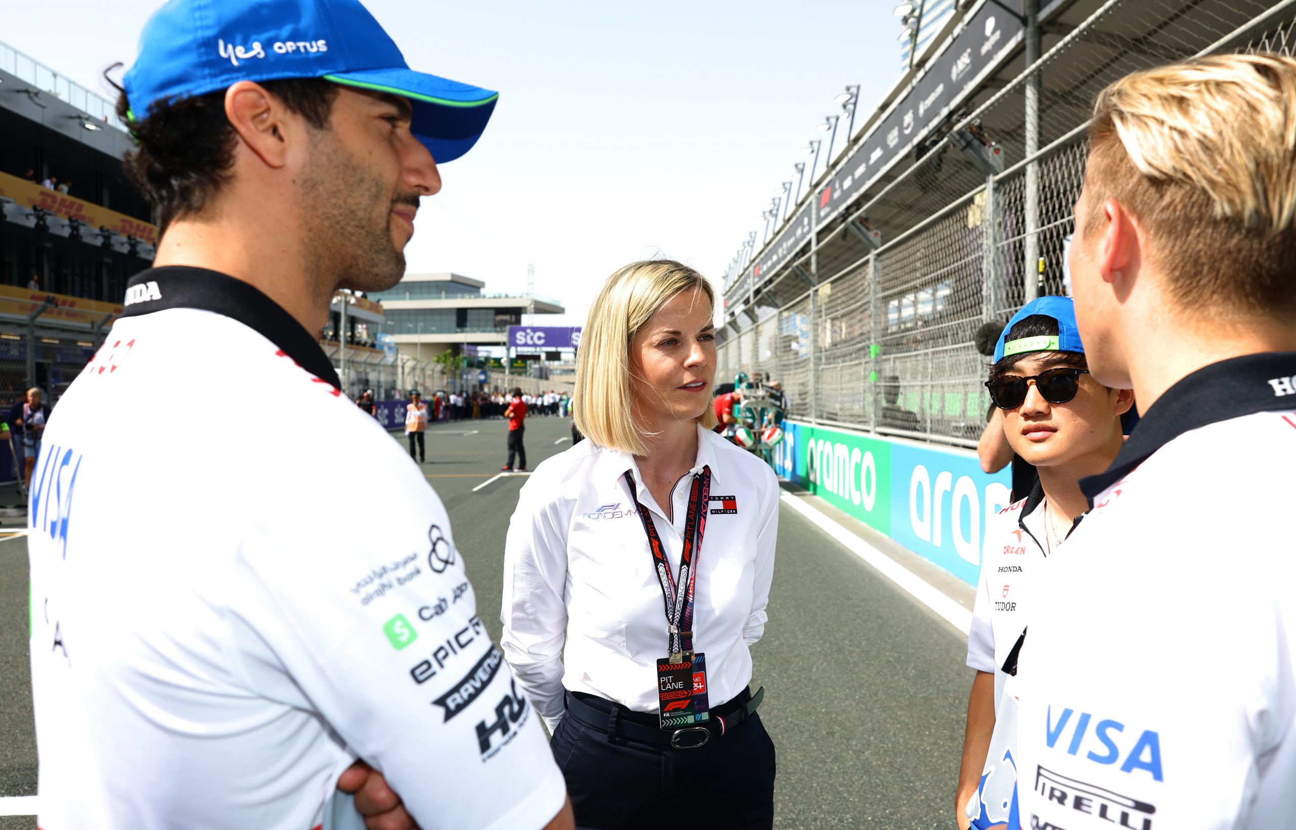 Susie Wolff (middle) managing director of F1 Academy talks with Daniel Ricciardo, Yuki Tsunoda, and Liam Lawson.