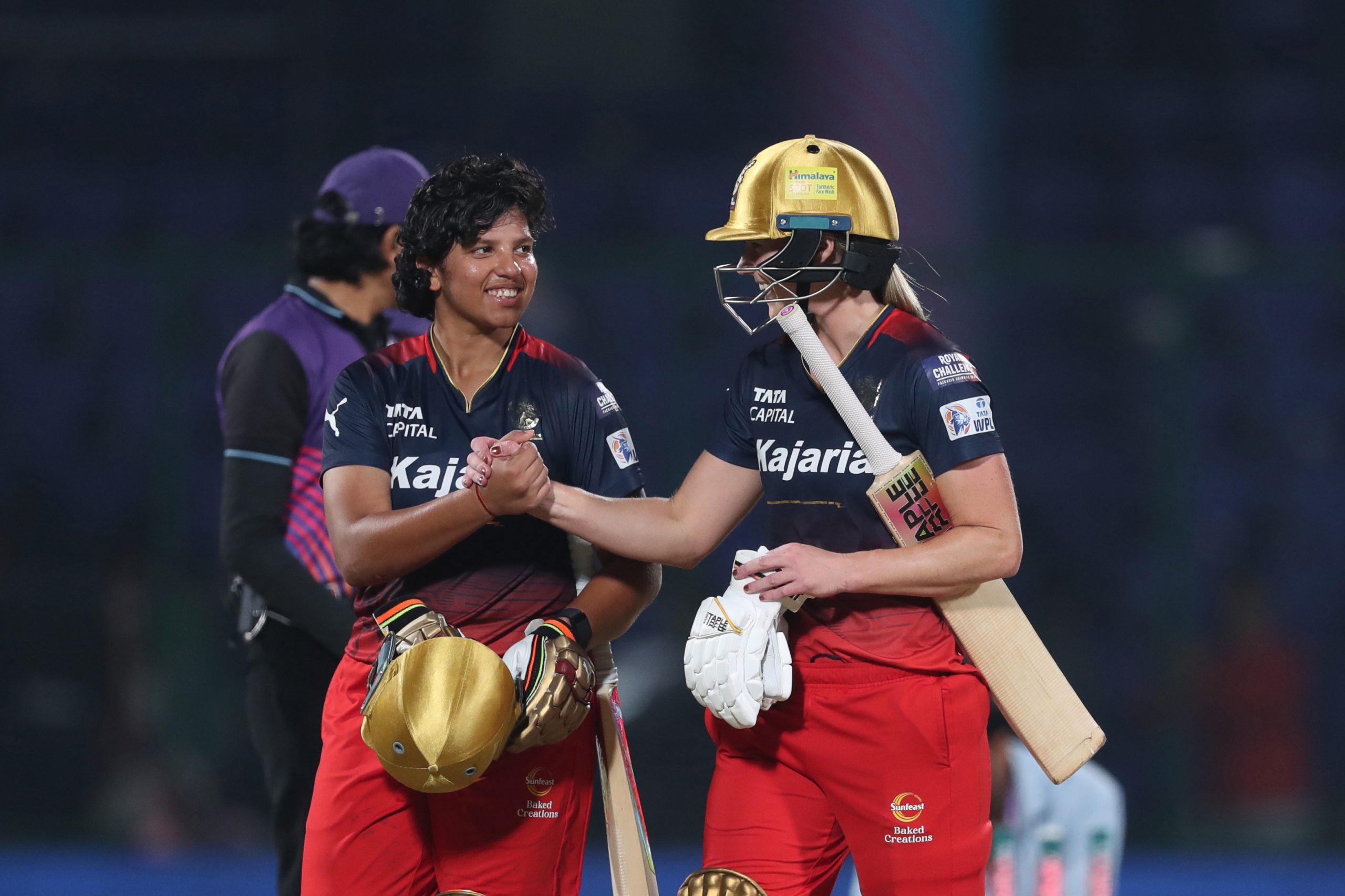 Richa Ghosh of Royal Challengers Bangalore and Ellyse Perry of Royal Challengers Bangalore celebrate their team's win over  Mumbai Indians during the WIPL match between Mumbai Indians and Royal Challengers at Arun Jaitley Stadium on March 12, 2024 in Delhi, India. (Photo by Pankaj Nangia/Getty Images)