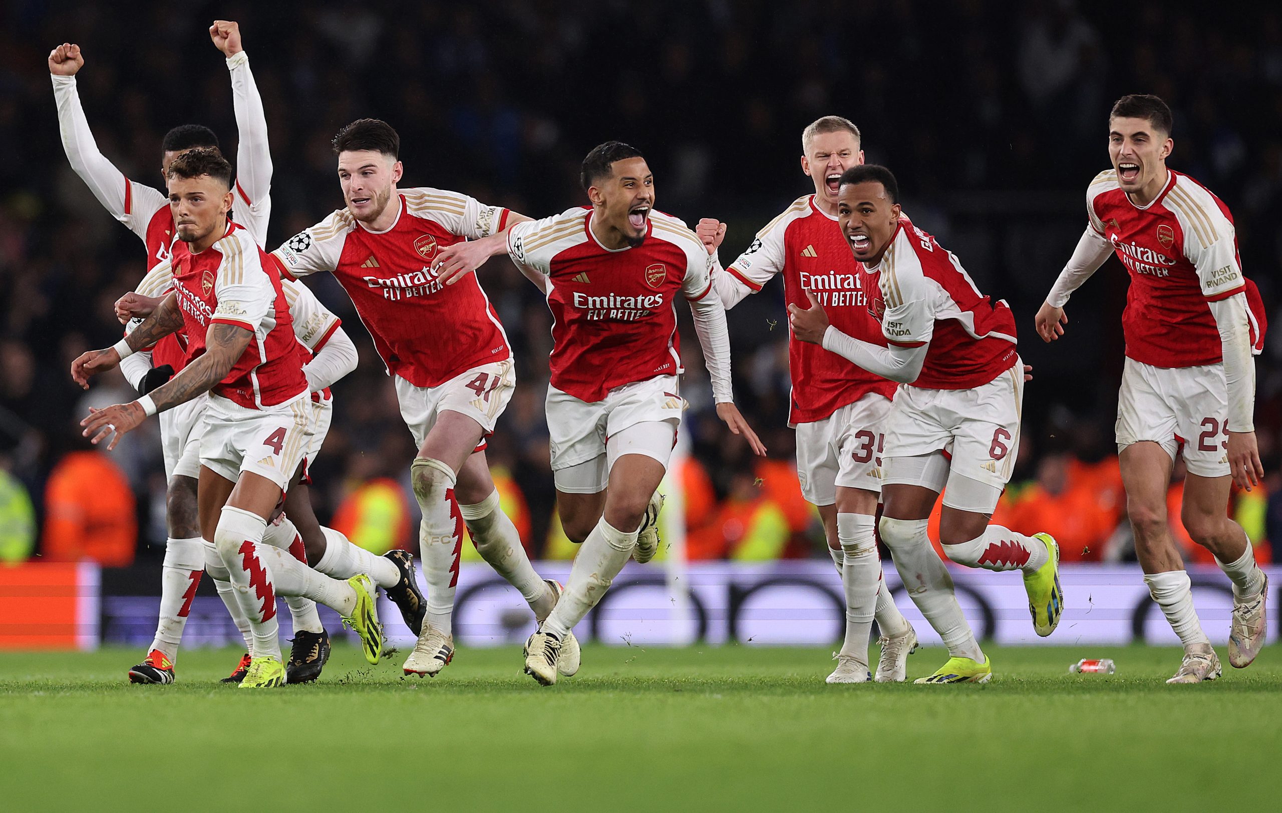 Players of Arsenal celebrate as David Raya of Arsenal (not pictured) makes the match-winning save from the fourth penalty from Galeno of FC Porto in the penalty shoot out during the UEFA Champions League.