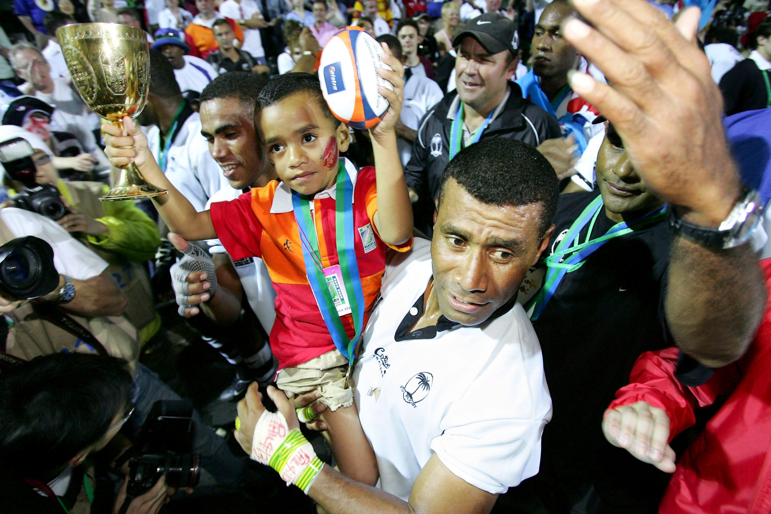 Captain Waisale Serevi of Fiji and his son Serevi Jr celebrate after defeating New Zealand.
