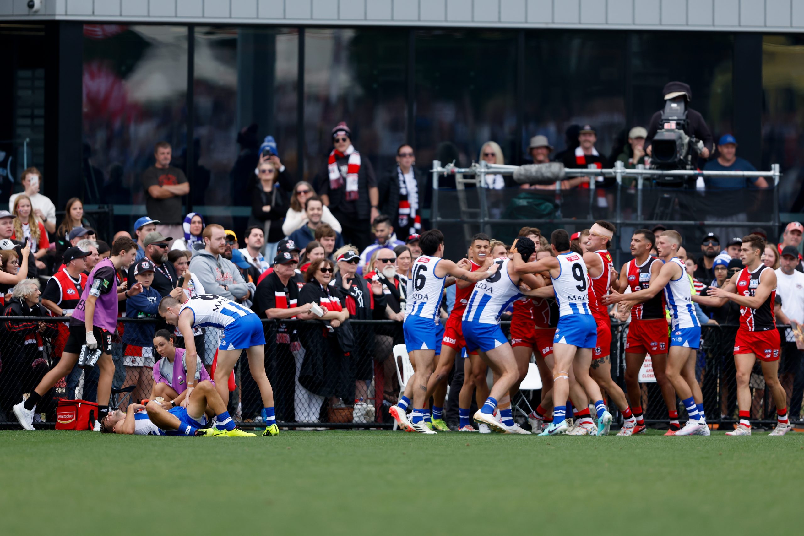 Players remonstrate as Jy Simpkin of the Kangaroos lays injured during the 2024 AFL AAMI Community Series match between the St Kilda Saints and North Melbourne Kangaroos at RSEA Park on March 03, 2024 in Melbourne, Australia. (Photo by Dylan Burns/AFL Photos via Getty Images)