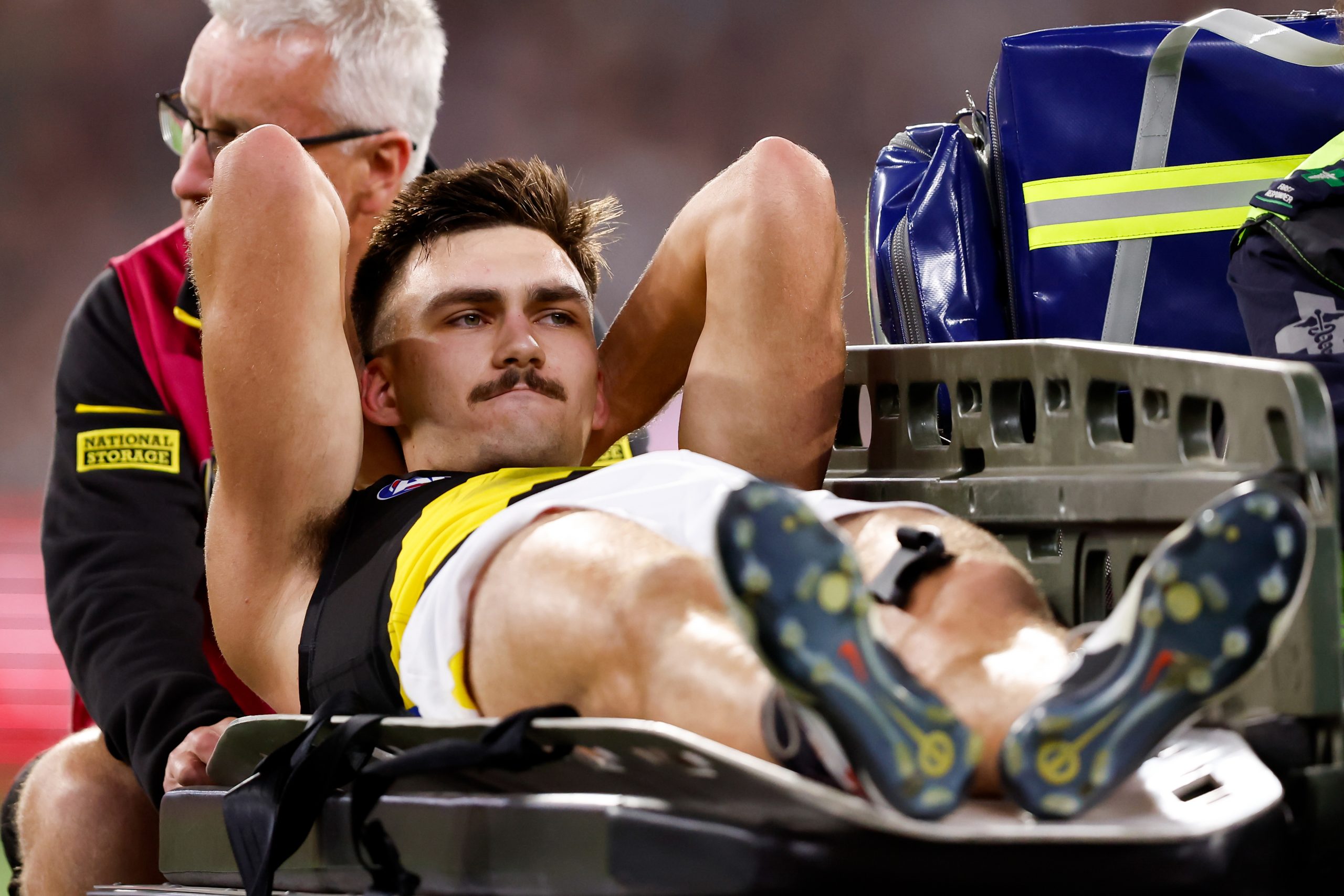 Josh Gibcus of the Tigers leaves the field on a stretcher during the 2024 AFL Round 01 match between the Carlton Blues and the Richmond Tigers at the Melbourne Cricket Ground on March 14, 2024 in Melbourne, Australia. (Photo by Dylan Burns/AFL Photos via Getty Images)