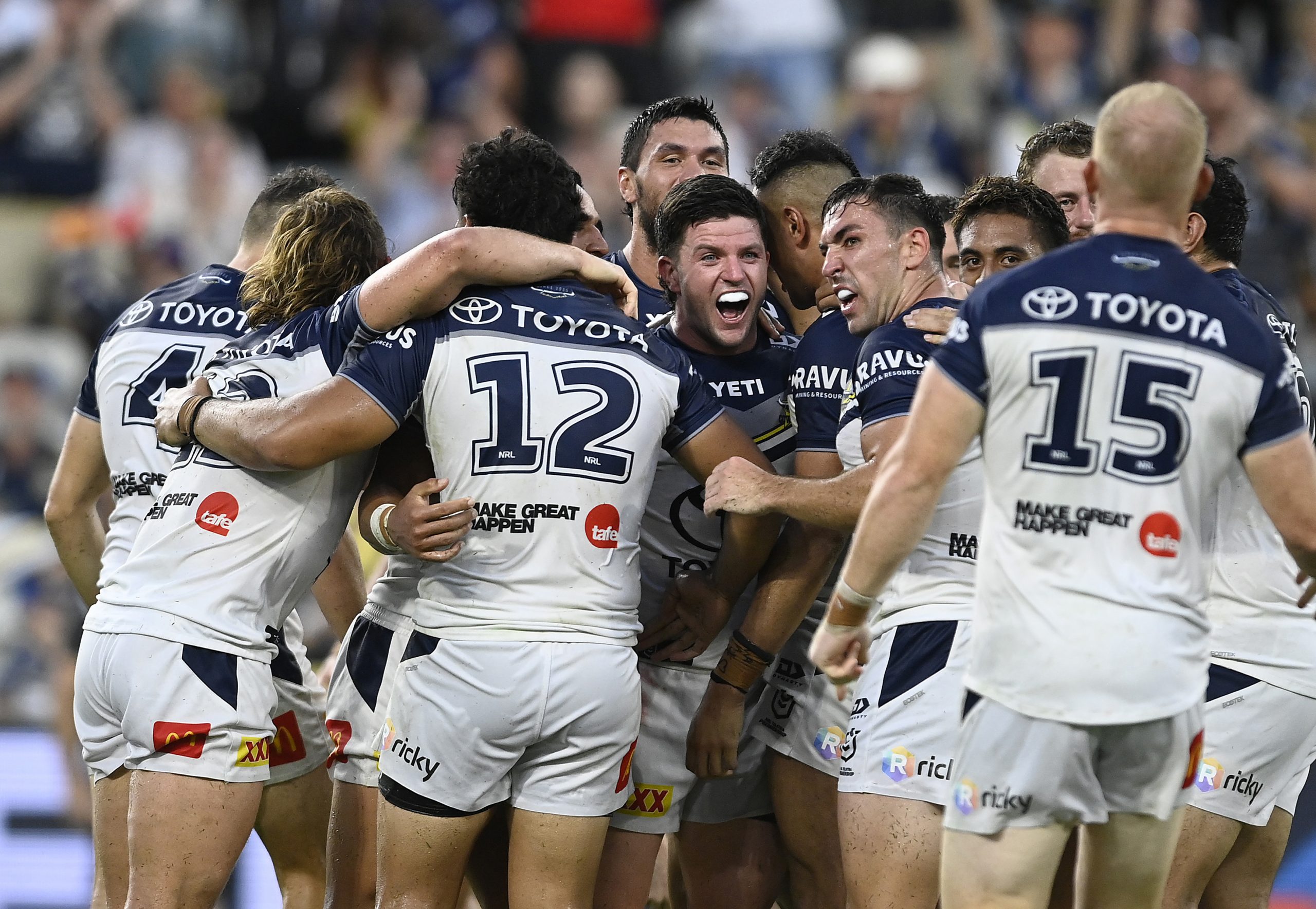 Chad Townsend celebrates with teammates after kicking the winning field goal during golden point.