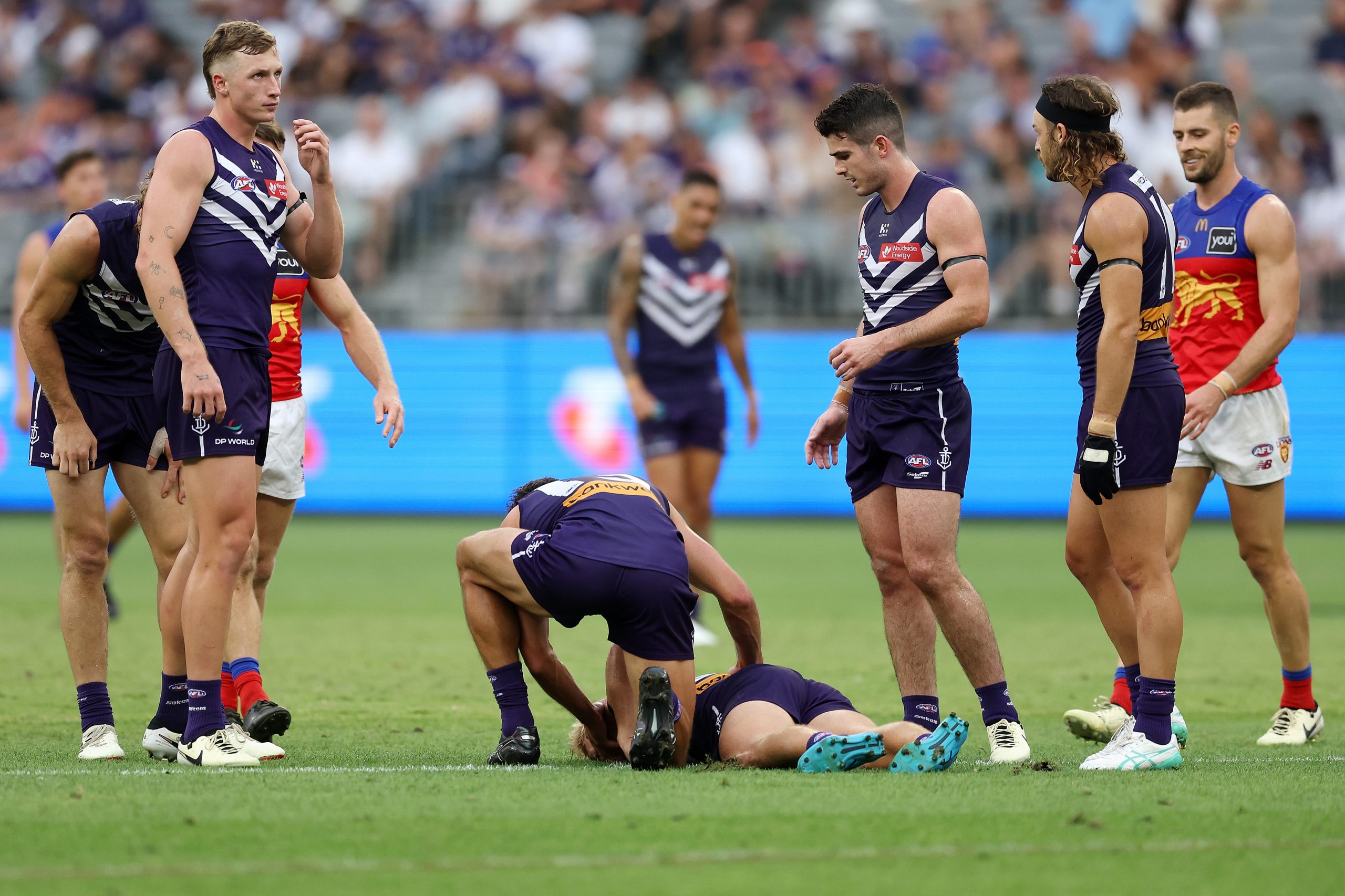 Worner is attended to by teammates after the hit.