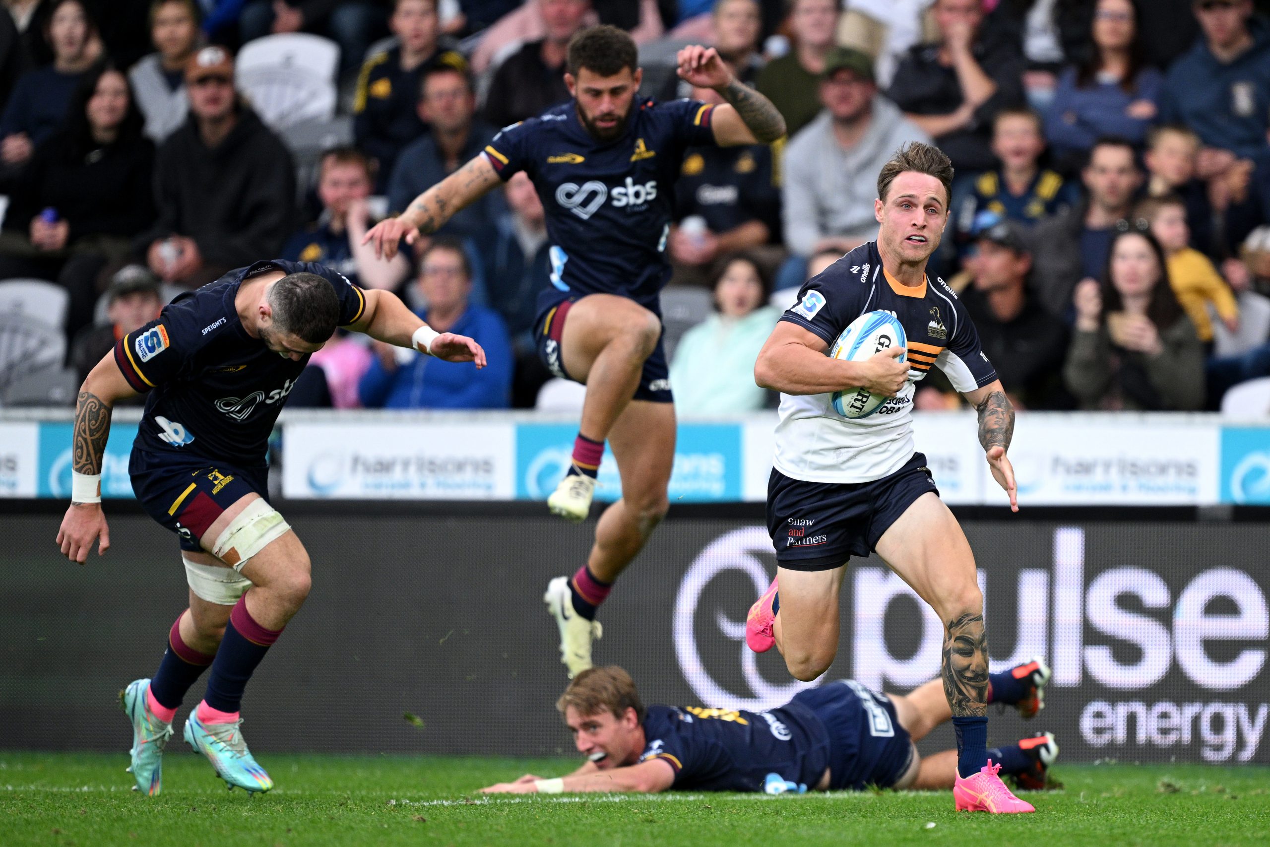 Corey Toole of the Brumbies charges towards the try line to score.