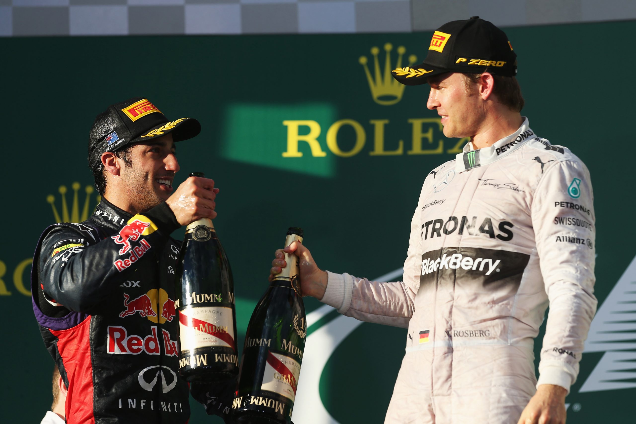 Daniel Ricciardo (left) celebrates on the podium with 2014 Australian Grand Prix winner Nico Rosberg.