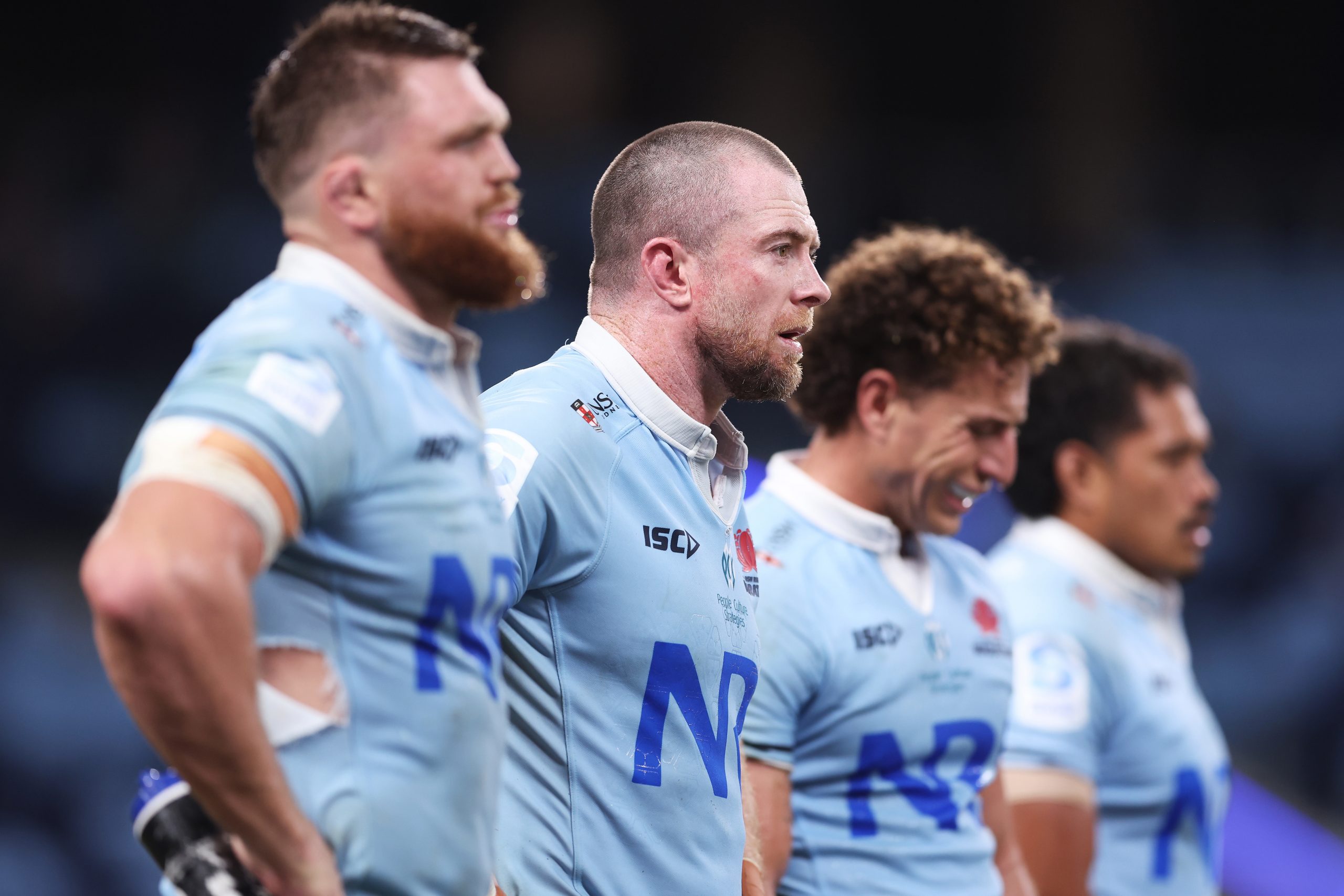 Jed Holloway and Waratahs teammates looks dejected after the final Rebels try during the round six Super Rugby Pacific match.