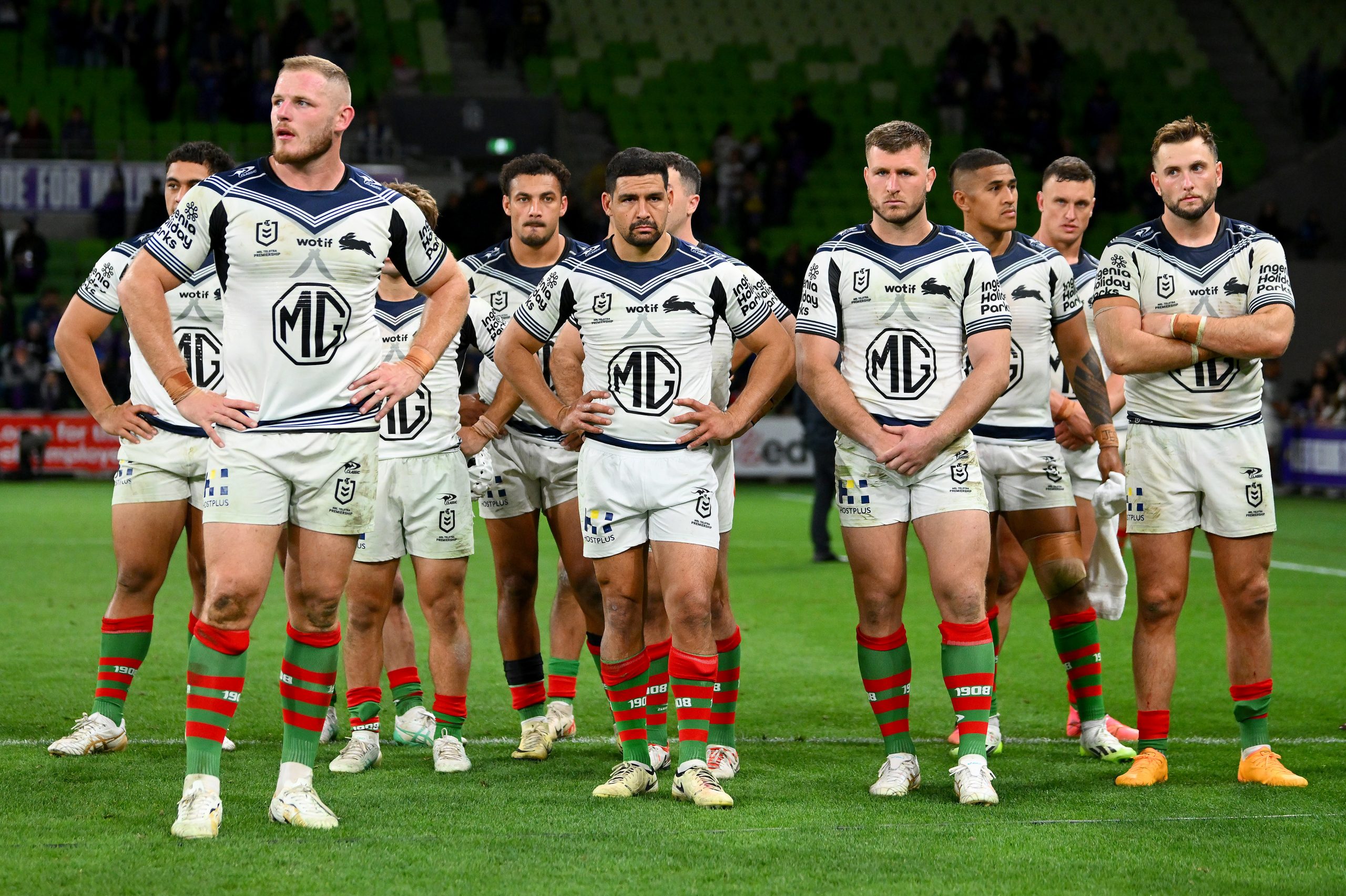 The Rabbitohs looking dejected during post-game formalities after the Anzac Day clash against the Storm.