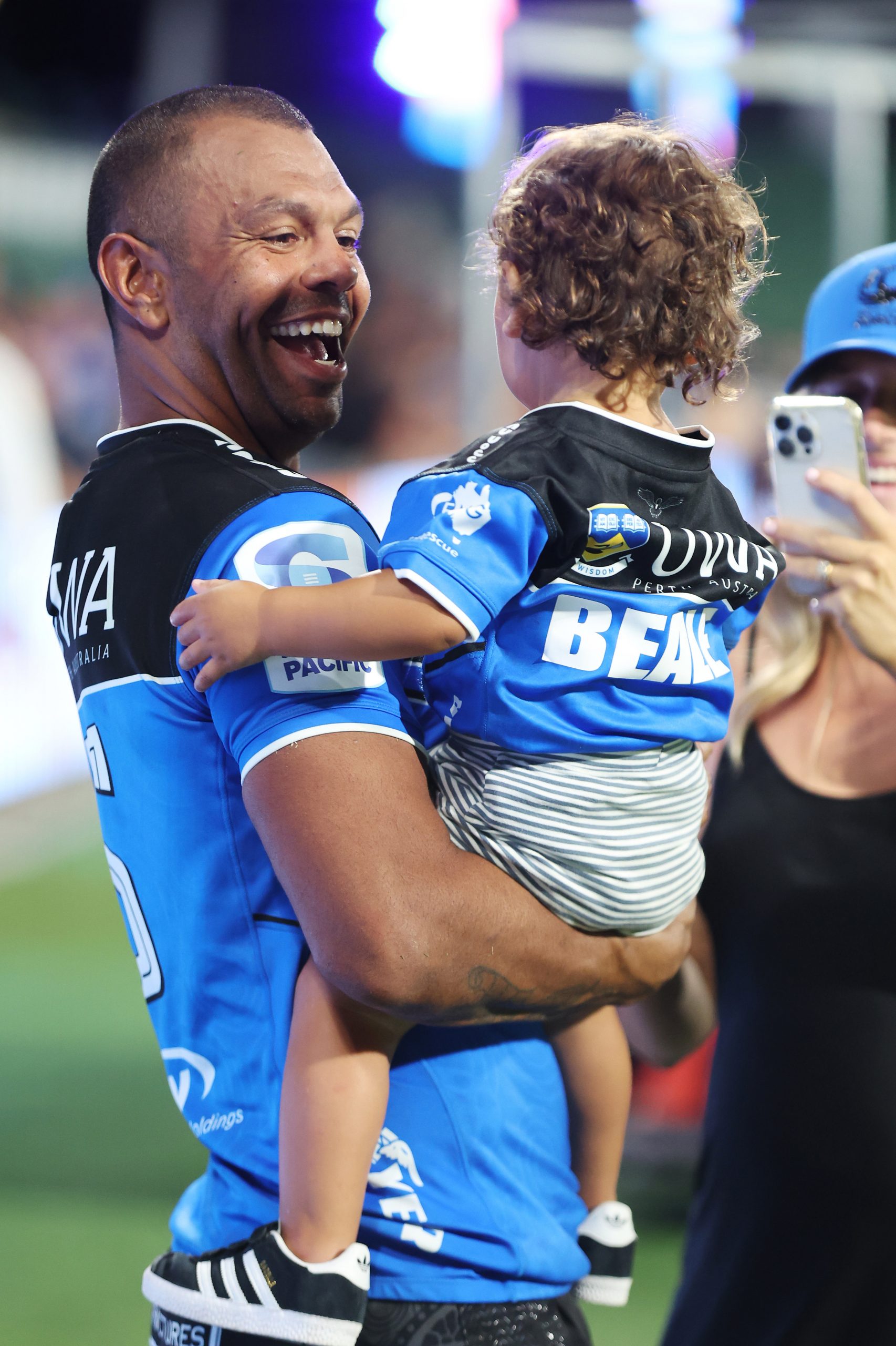 Kurtley Beale of the Force celebrates with his child after winning.