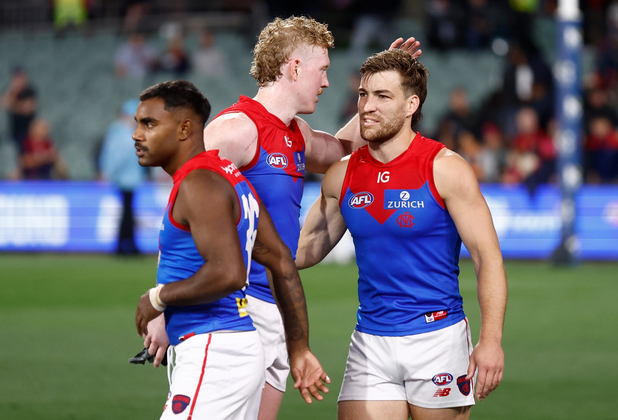 Kysaiah Pickett, Clayton Oliver and Jack Viney celebrate the Demons' win.