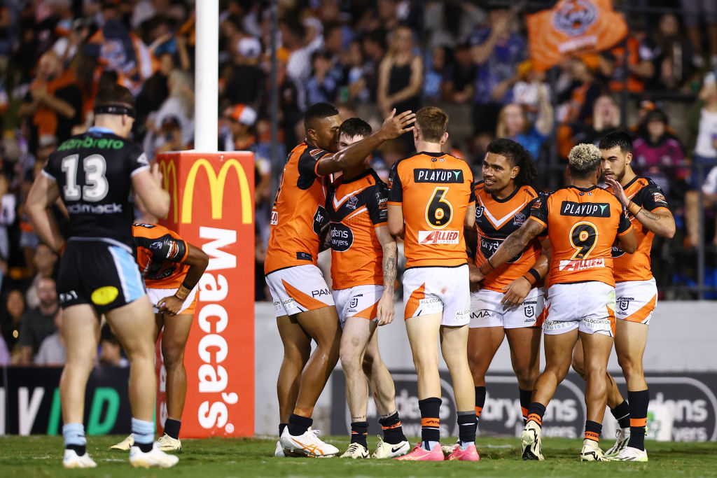 The Tigers celebrate scoring a try during the round three NRL match between Wests Tigers and Cronulla Sharks at Leichhardt Oval.