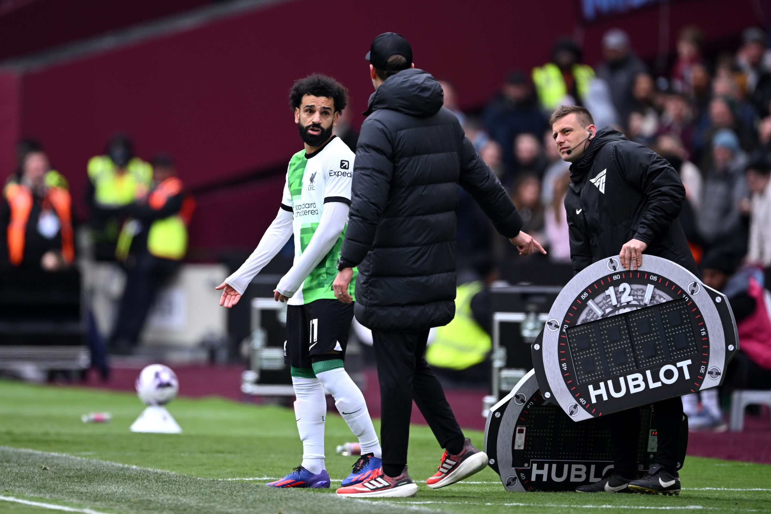 Mohamed Salah of Liverpool argues with Jurgen Klopp, Manager of Liverpool on the touch line ahead of a substitution during the Premier League match between West Ham United and Liverpool FC at London Stadium on April 27, 2024 in London, England. (Photo by Justin Setterfield/Getty Images)
