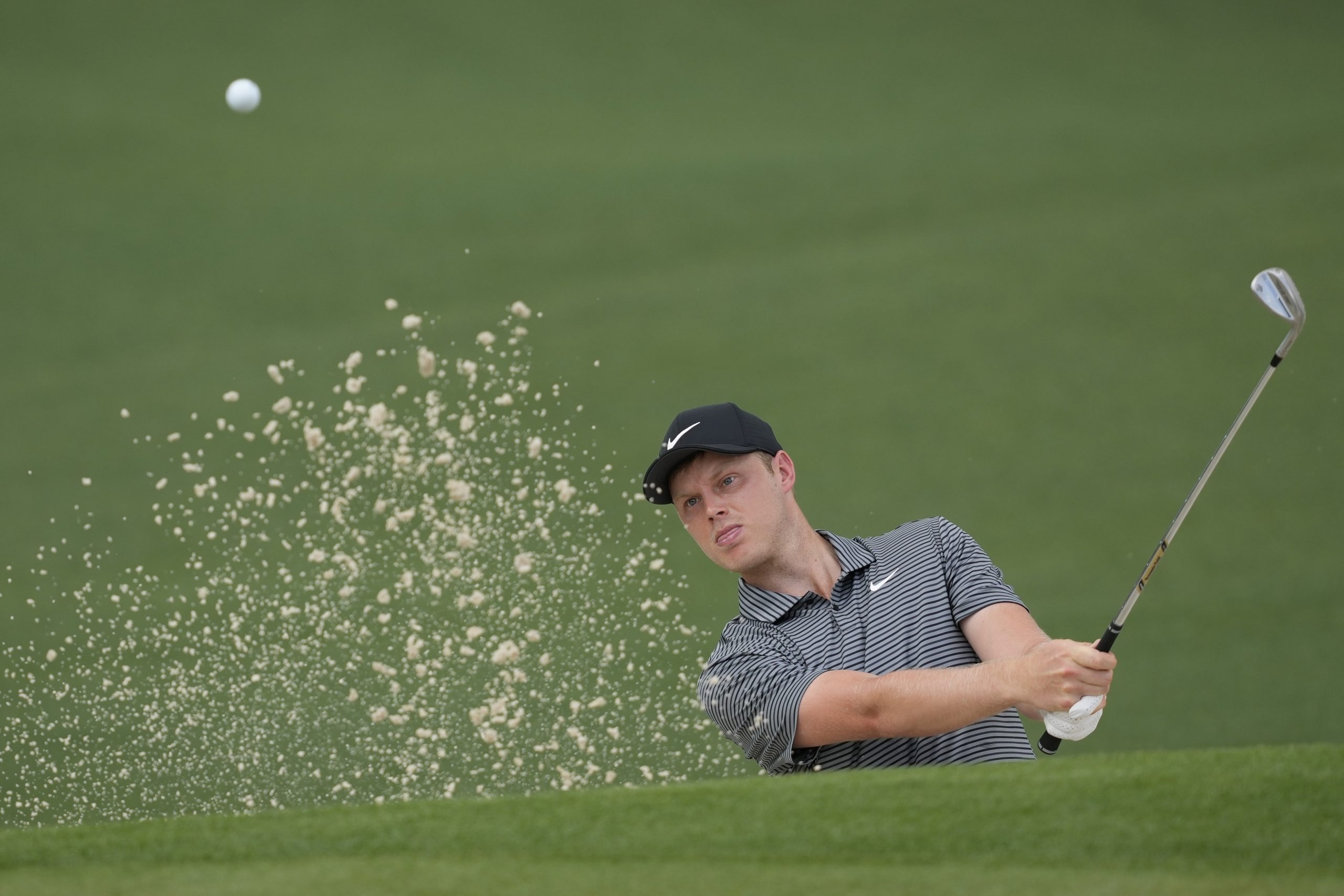Cam Davis, of Australia, hits from the bunker.