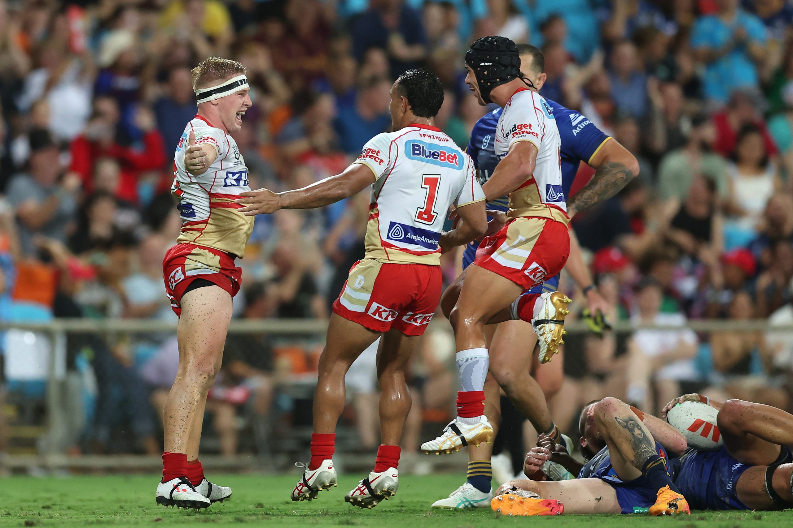 Max Plath celebrates with teammates after scoring a try during the round seven NRL match between the Parramatta Eels and the Dolphins.
