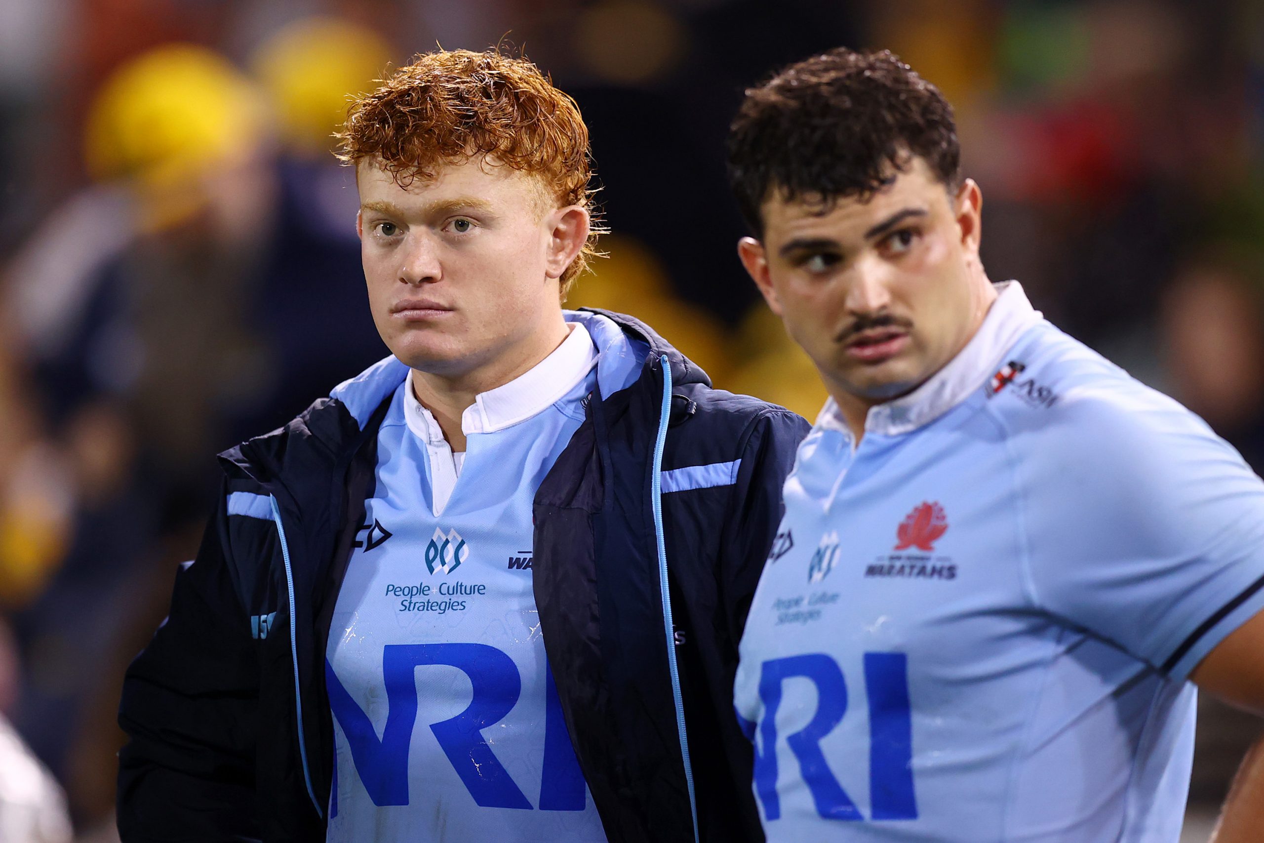 Jake Edmed of the Waratahs watches on from the bench during the round seven Super Rugby Pacific match between ACT Brumbies and NSW Waratahs.
