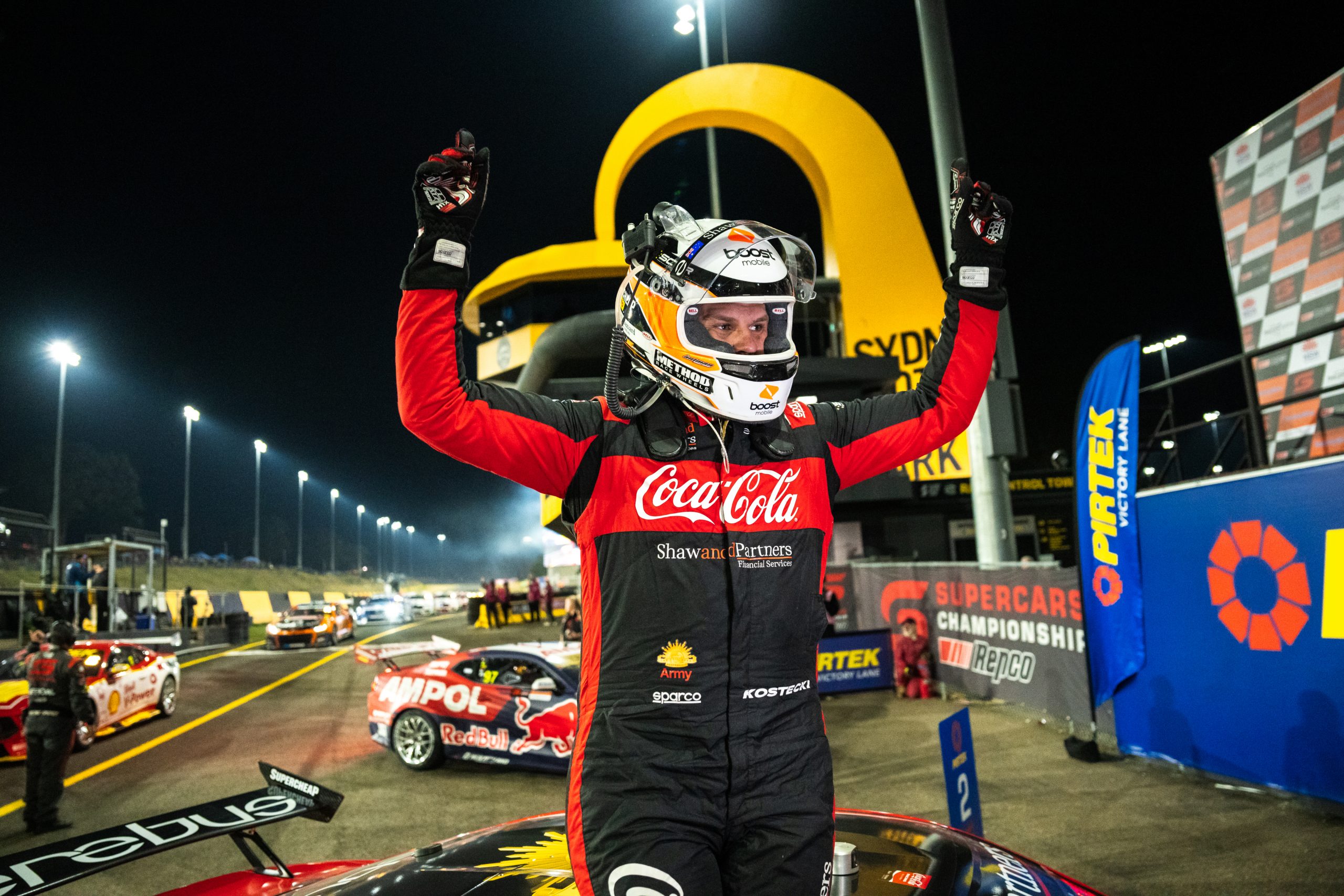 Brodie Kostecki celebrates victory at Sydney Motorsport Park, wearing is Boost Mobile-sponsored helmet.