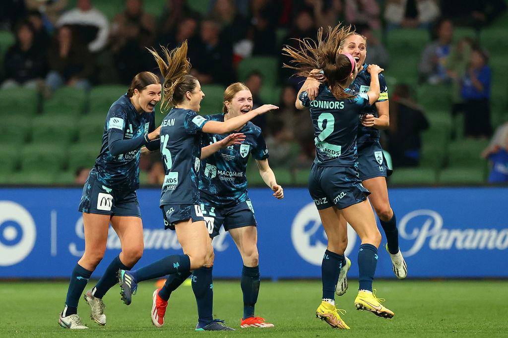 Shea Conn­ors celebrates with her teammates after scoring.