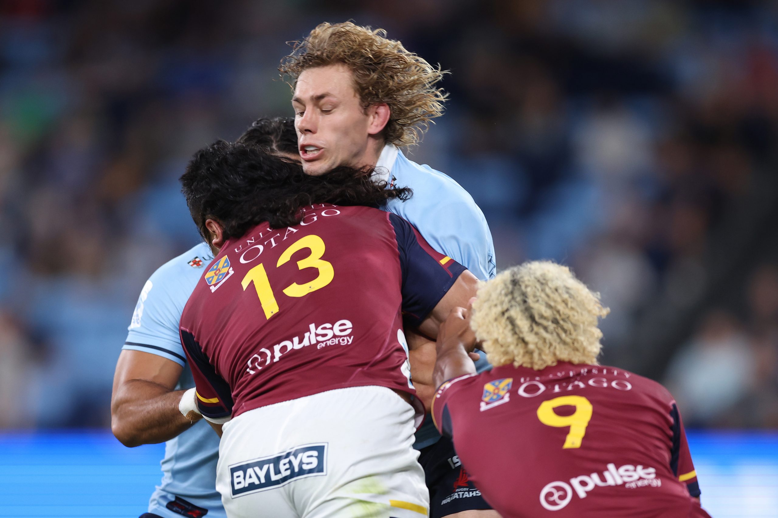 Ned Hanigan of the Waratahs is tackled.