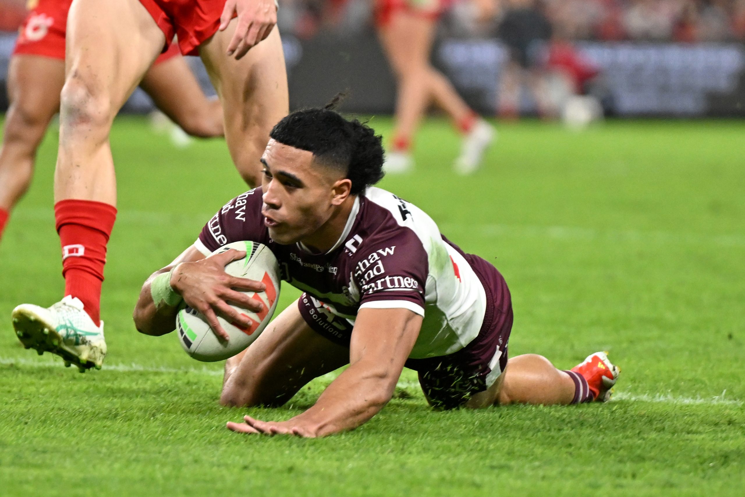 Tolutau Koula scores for the Sea Eagles against the Dolphins.