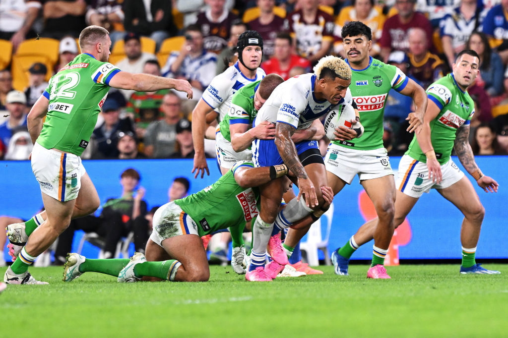 Viliame Kikau tackled by Raiders defenders.