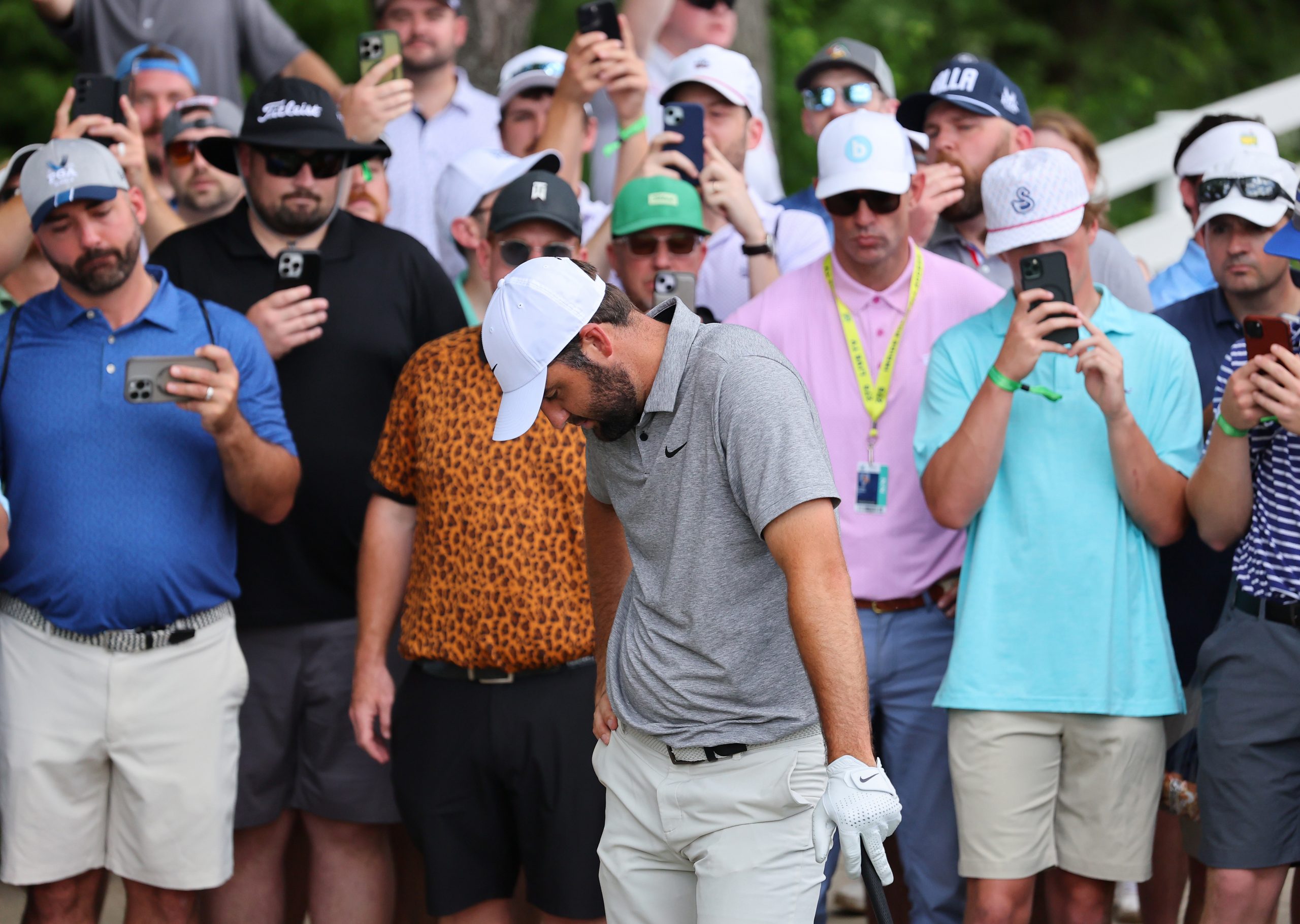 Spectators look on as Scottie Scheffler of the United States prepares to take a drop on the fourth hole during the third round of the 2024 PGA Championship at Valhalla Golf Club on May 18, 2024 in Louisville, Kentucky. (Photo by Michael Reaves/Getty Images)