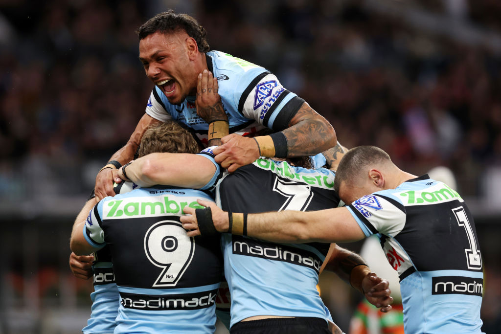 Jesse Ramien jumps on Sione Katoa as the Sharks celebrate a try.