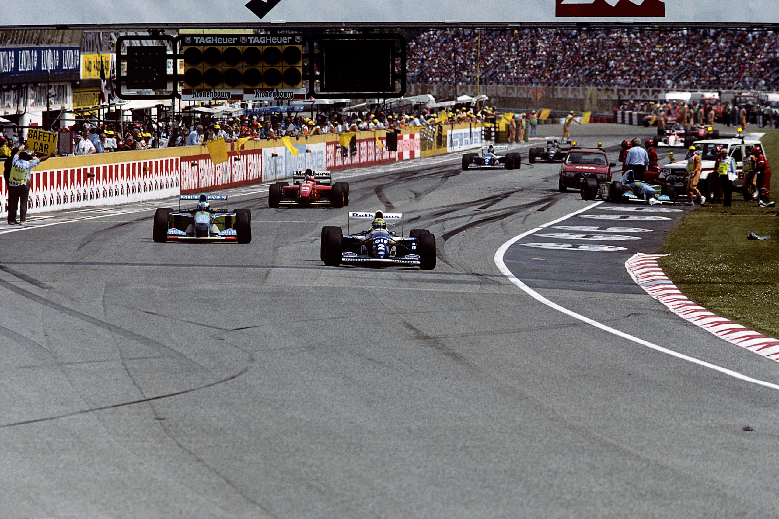 Ayrton Senna, Michael Schumacher, Gerhard Berger, Williams-Renault FW16, Benetton-Ford B194, Ferrari 412T1, Grand Prix of San Marino, Autodromo Enzo e Dino Ferrari, Imola, 01 May 1994. End of the first lap of the 1994 San Marino Grand Prix in Imola: Ayrton Senna ahead of Michael Schumacher under yellow flag and Safety car, with JJ Lehto's Benetton, which stalled and crashed at the start, visible on the right. (Photo by Paul-Henri Cahier/Getty Images)