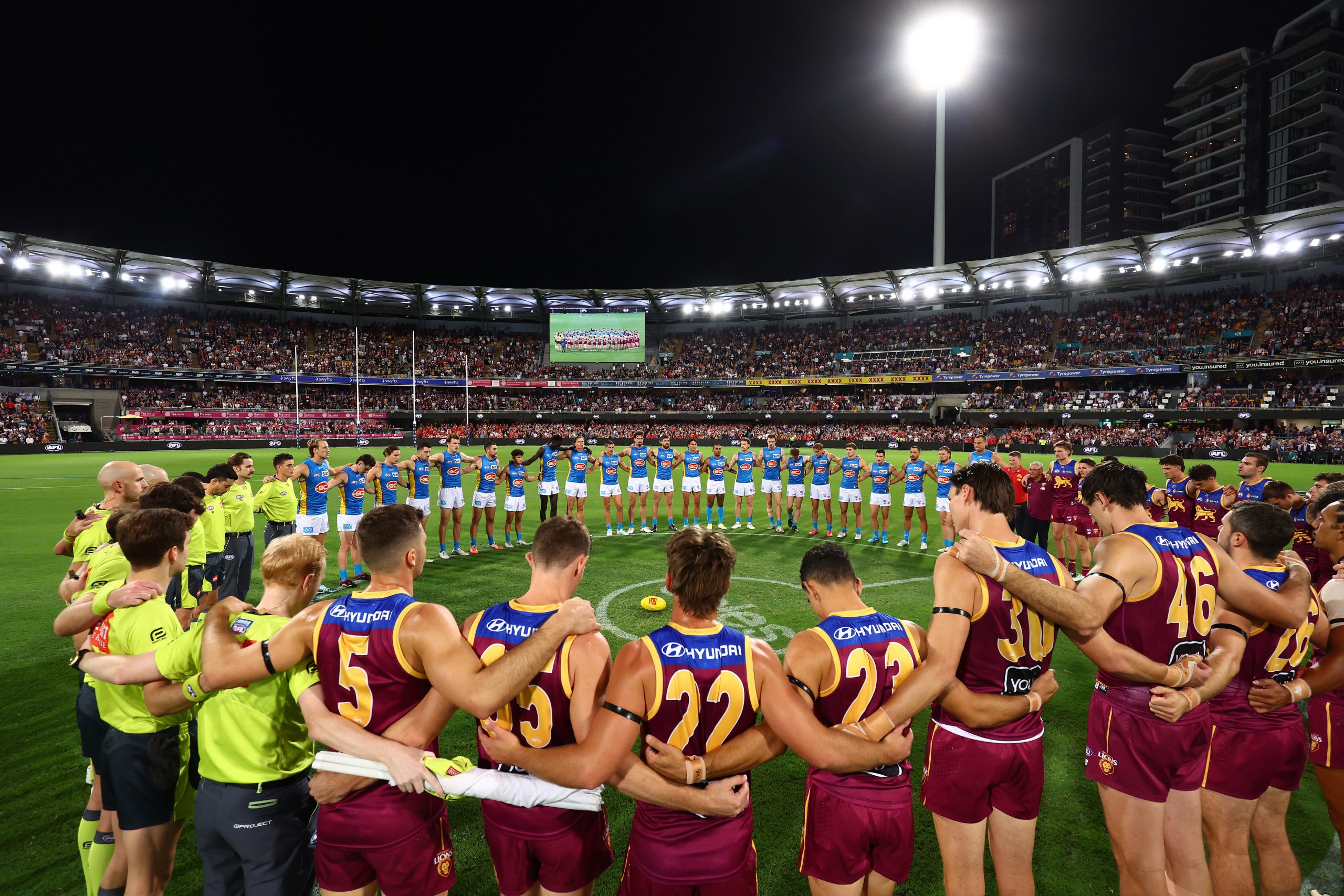 Players, coaches and officials stood arm in arm.