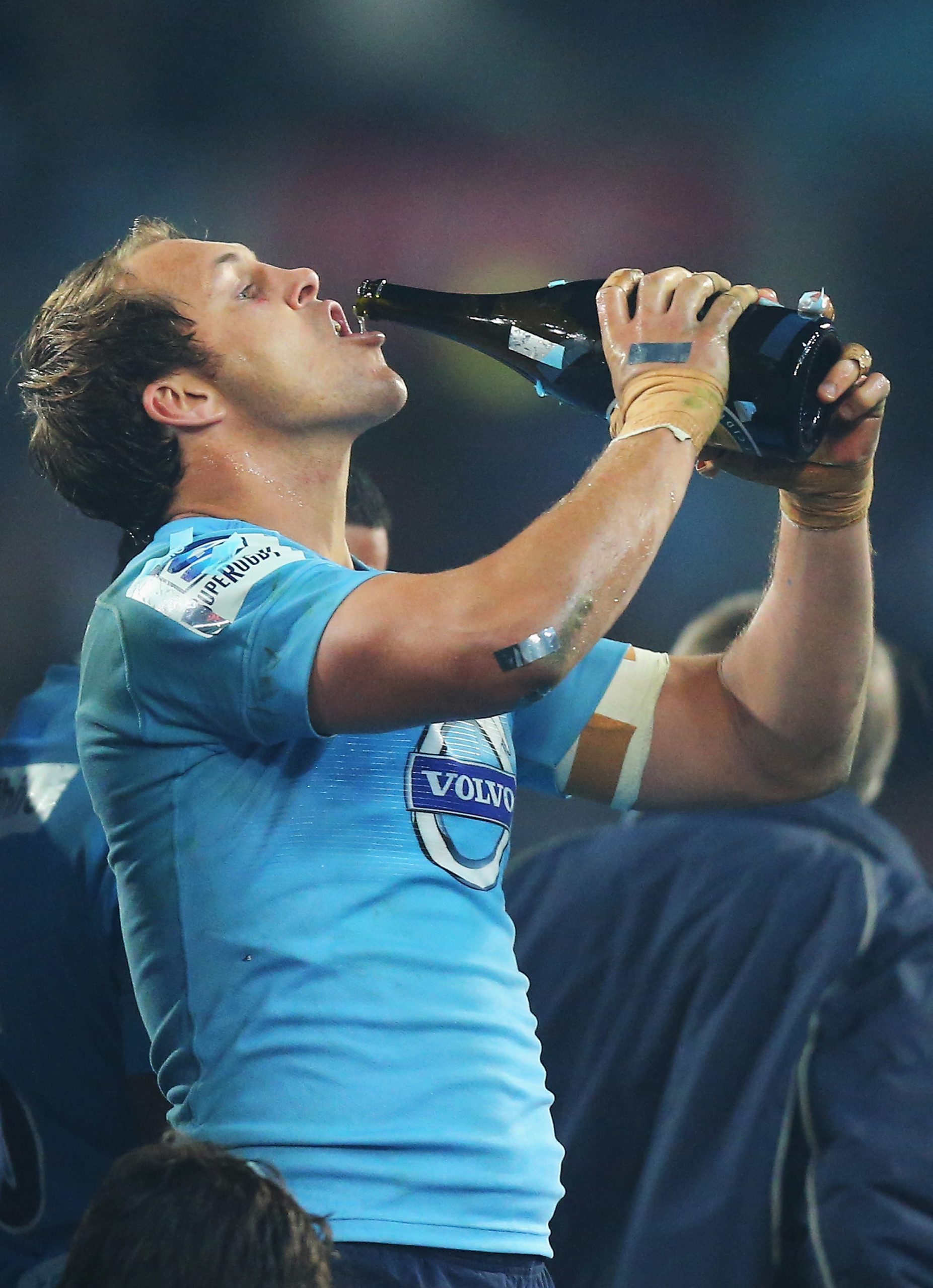 Stephen Hoiles of the Waratahs drinks champagne after winning the 2014 Super Rugby title.
