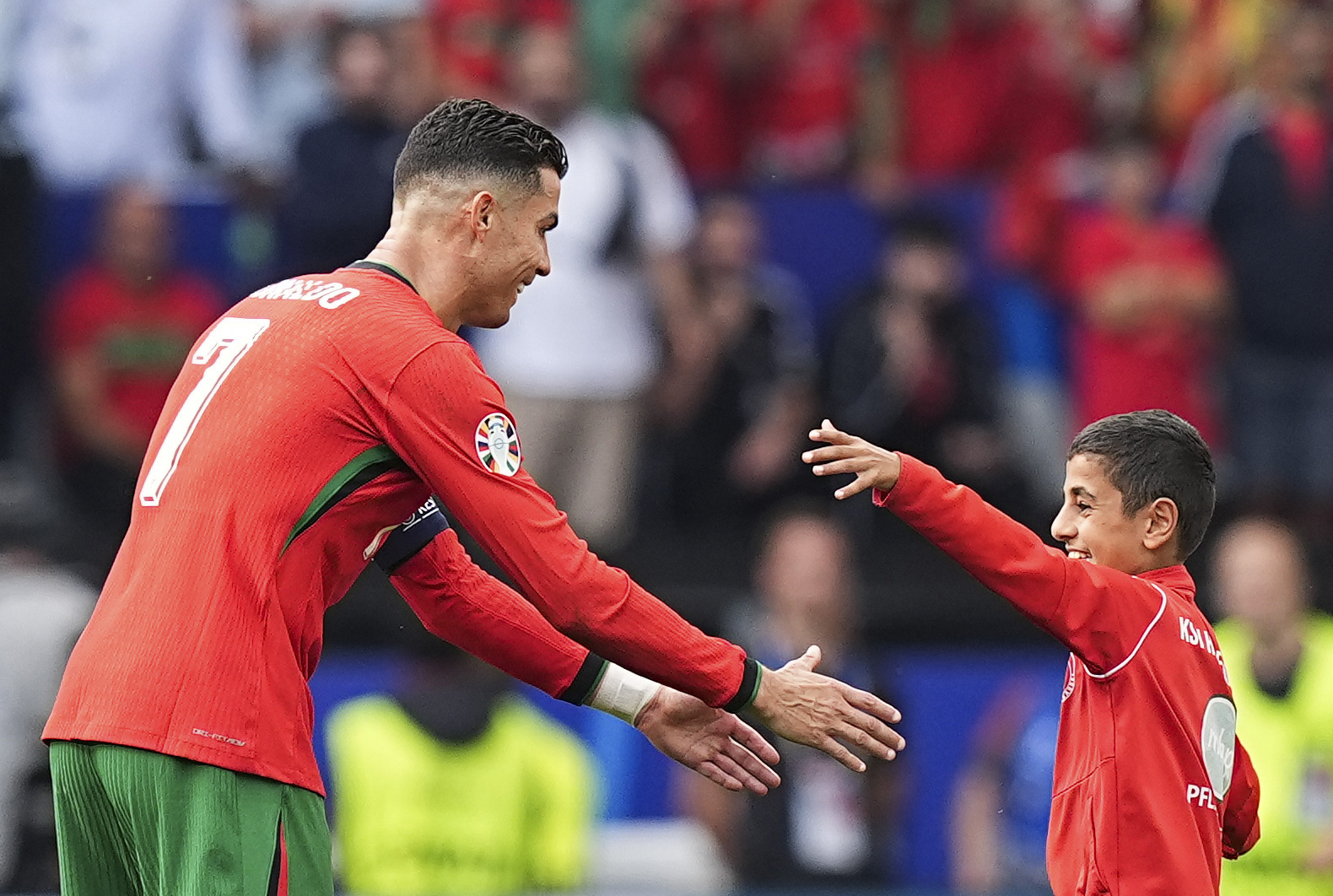 A kid takes a selfie with Cristiano Ronaldo during UEFA EURO 2024 Group F football match between Turkiye and Portugal at Westfalenstadion in Dortmund, Germany on June 22, 2024. (Photo by Emin Sansar/Anadolu via Getty Images)