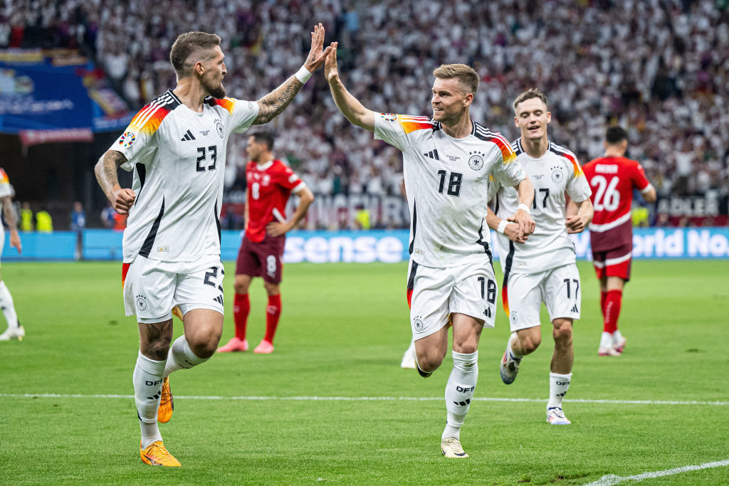 Robert Andrich (left) celebrates an invalid goal with Maximilian Mittelstaedt (18) and Florian Wirtz (17).